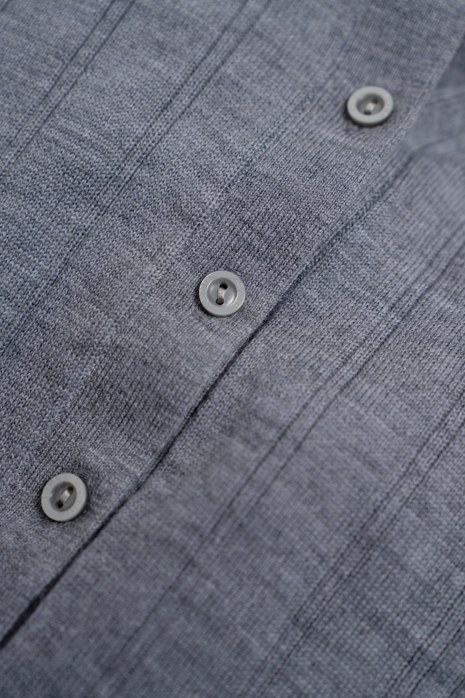 Close-up of a gray textured shirt with buttons