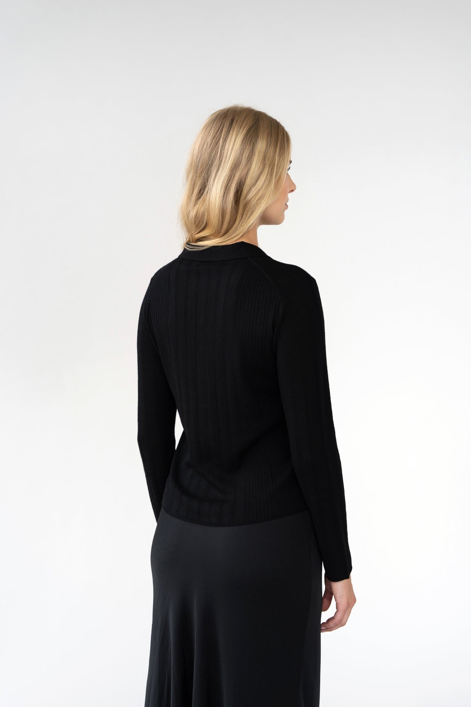 On-model back view of ribbed knit collared cardigan, black, studio.