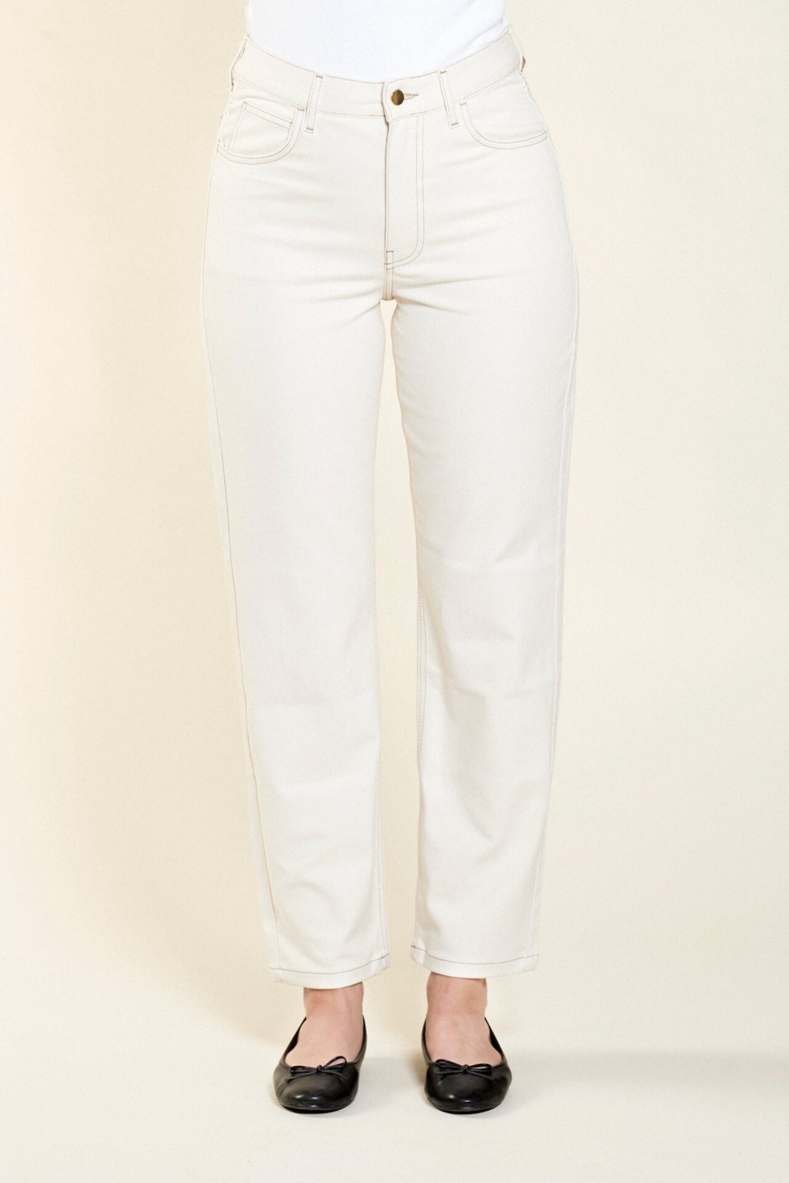 Front view of Cyme Copenhagen's classic cream denim trousers, showcasing the sophisticated cut and sustainable quality materials characteristic of the Danish designer fashion brand.