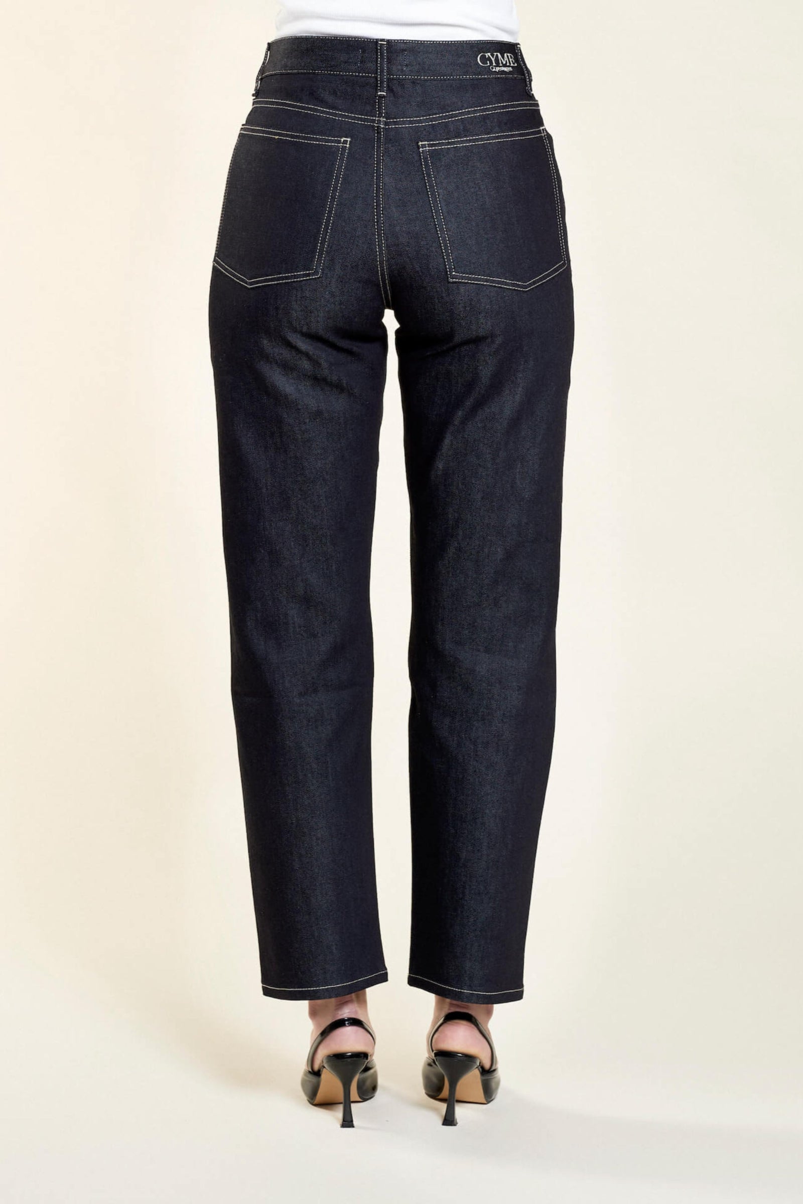 Full-length back view of Cyme Copenhagen's dark denim jeans, accentuating the natural fabric and timeless design, tailored for the fashion-conscious individual.