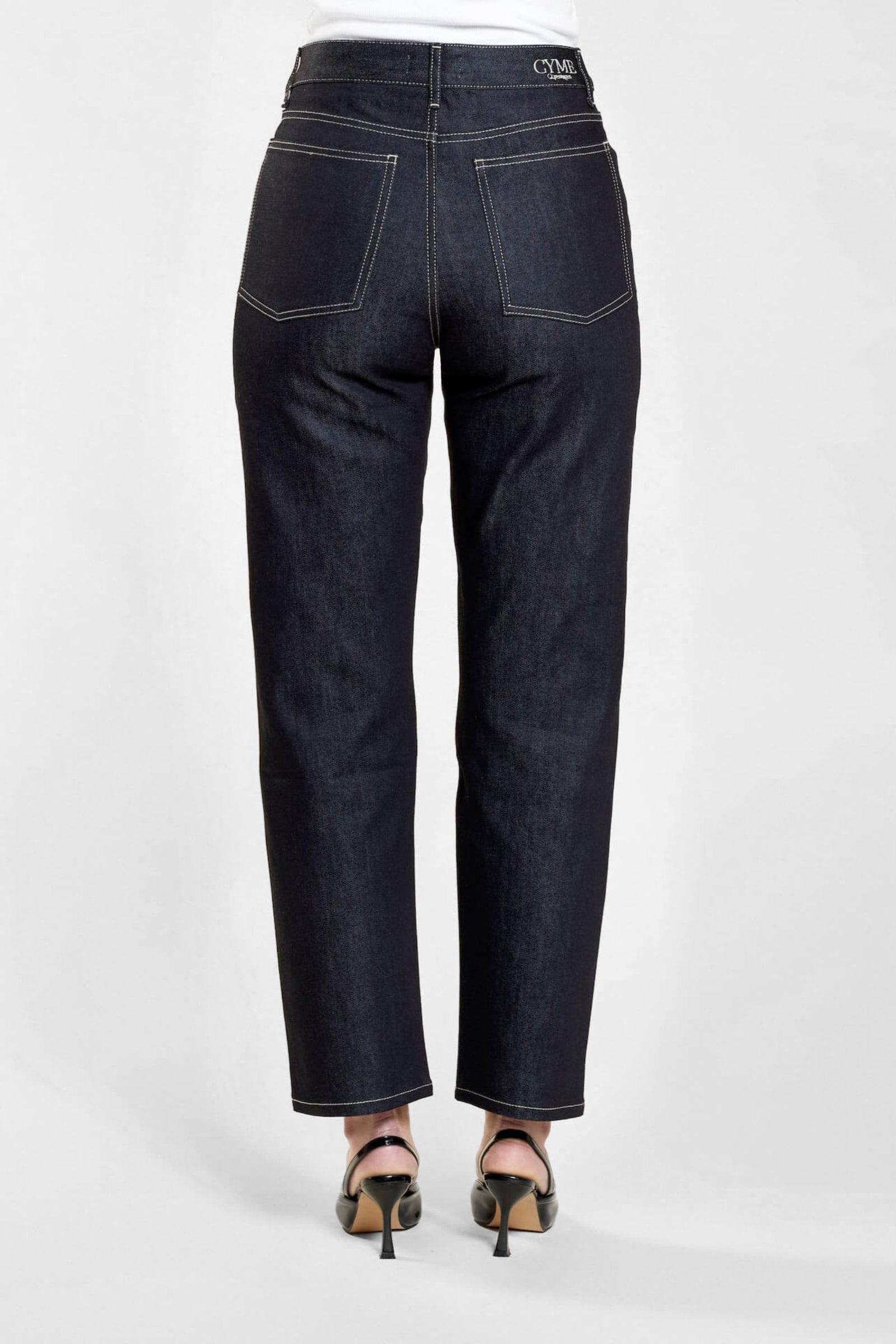 Full-length back view of Cyme Copenhagen's dark denim jeans, accentuating the natural fabric and timeless design, tailored for the fashion-conscious individual.
