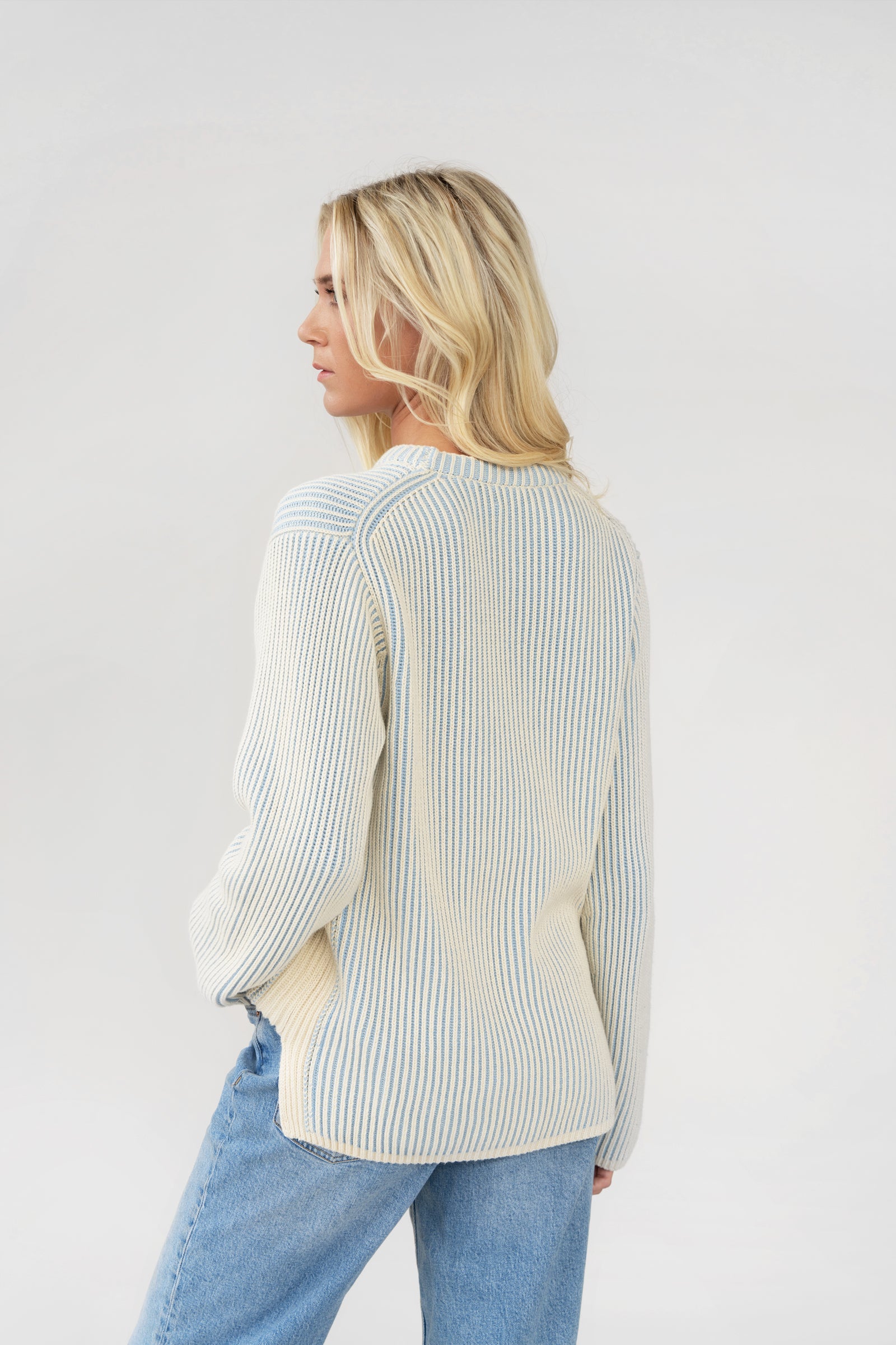 woman wearing a blue and white striped jumper.