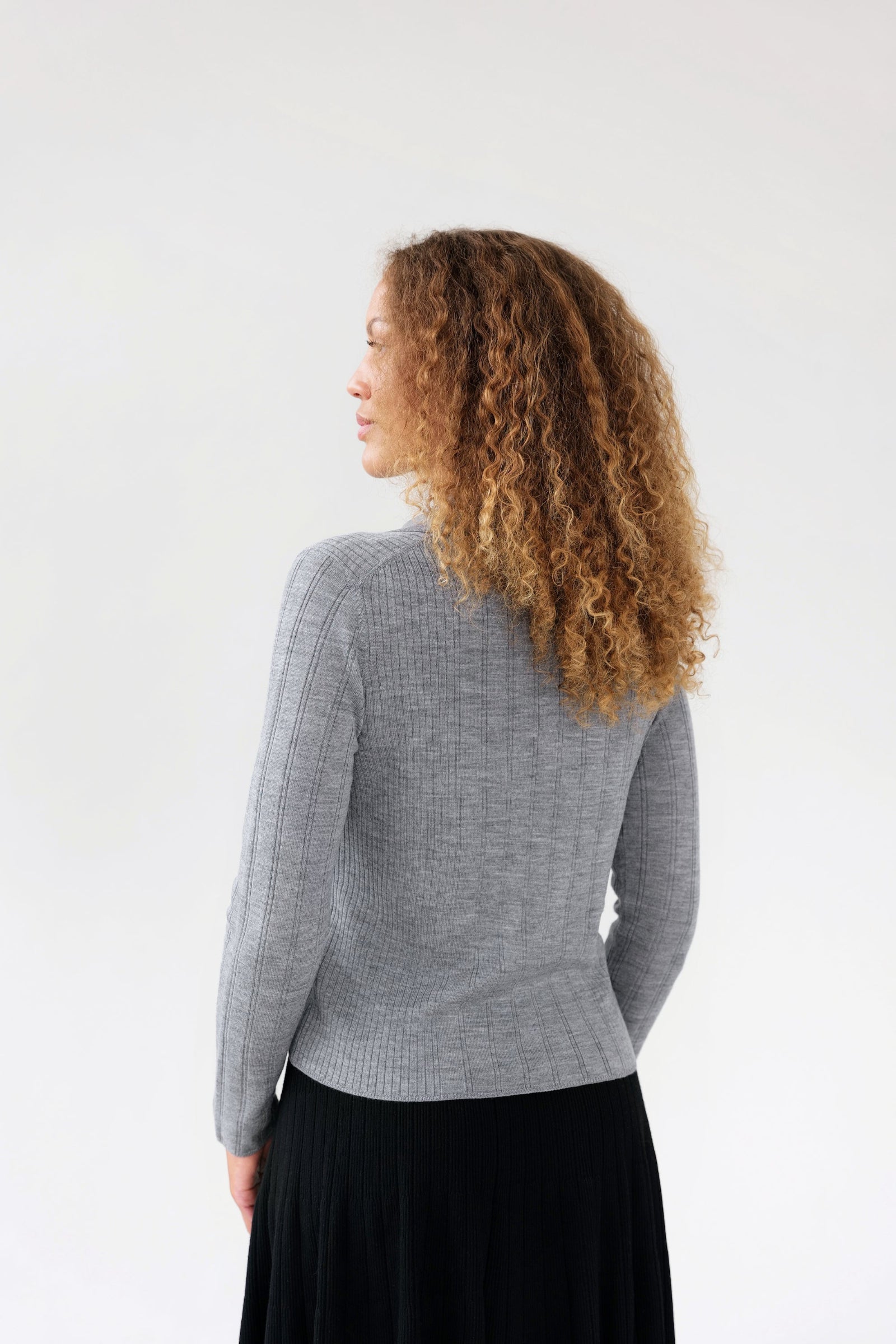 On-model back view of ribbed knit collared cardigan, light grey, studio.
