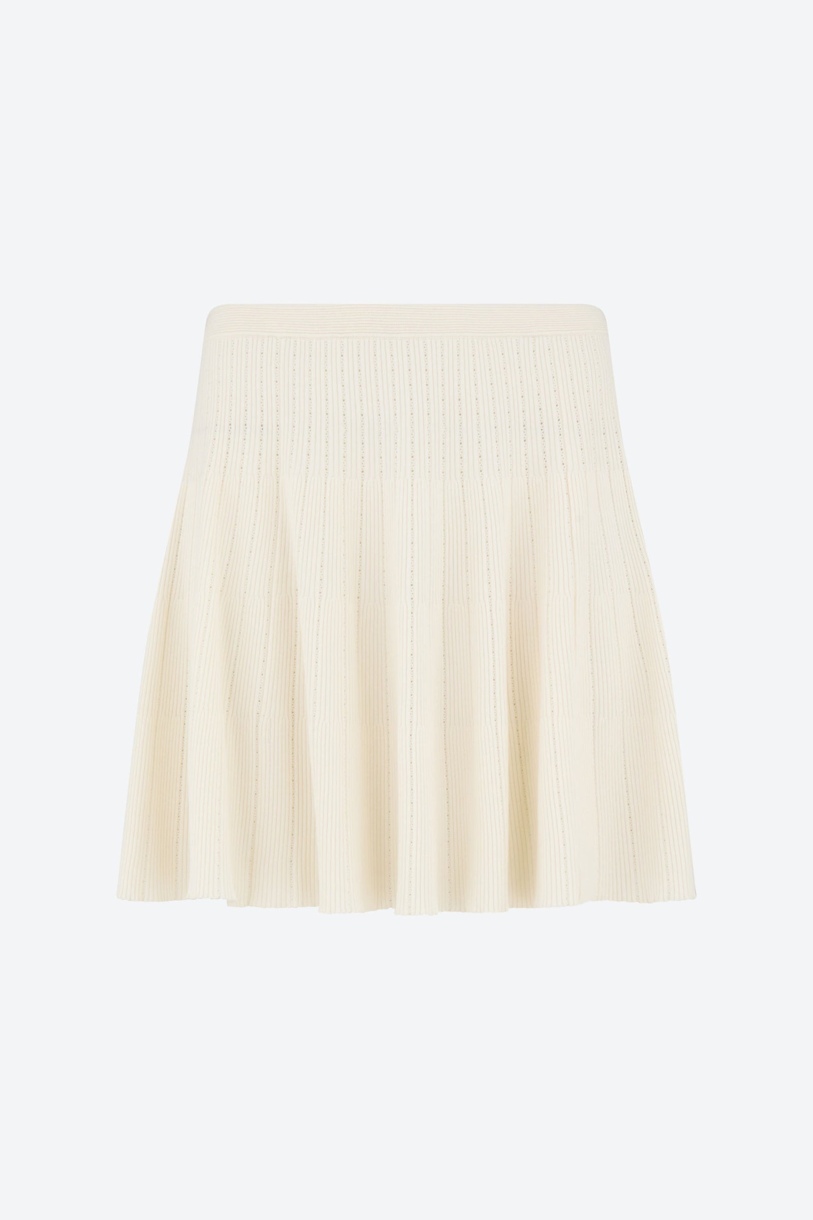 Front view of the CYME Knit Skirt in ivory. Crafted in a refined ribbed knit, this skirt flows with movement while maintaining a flattering, feminine silhouette.