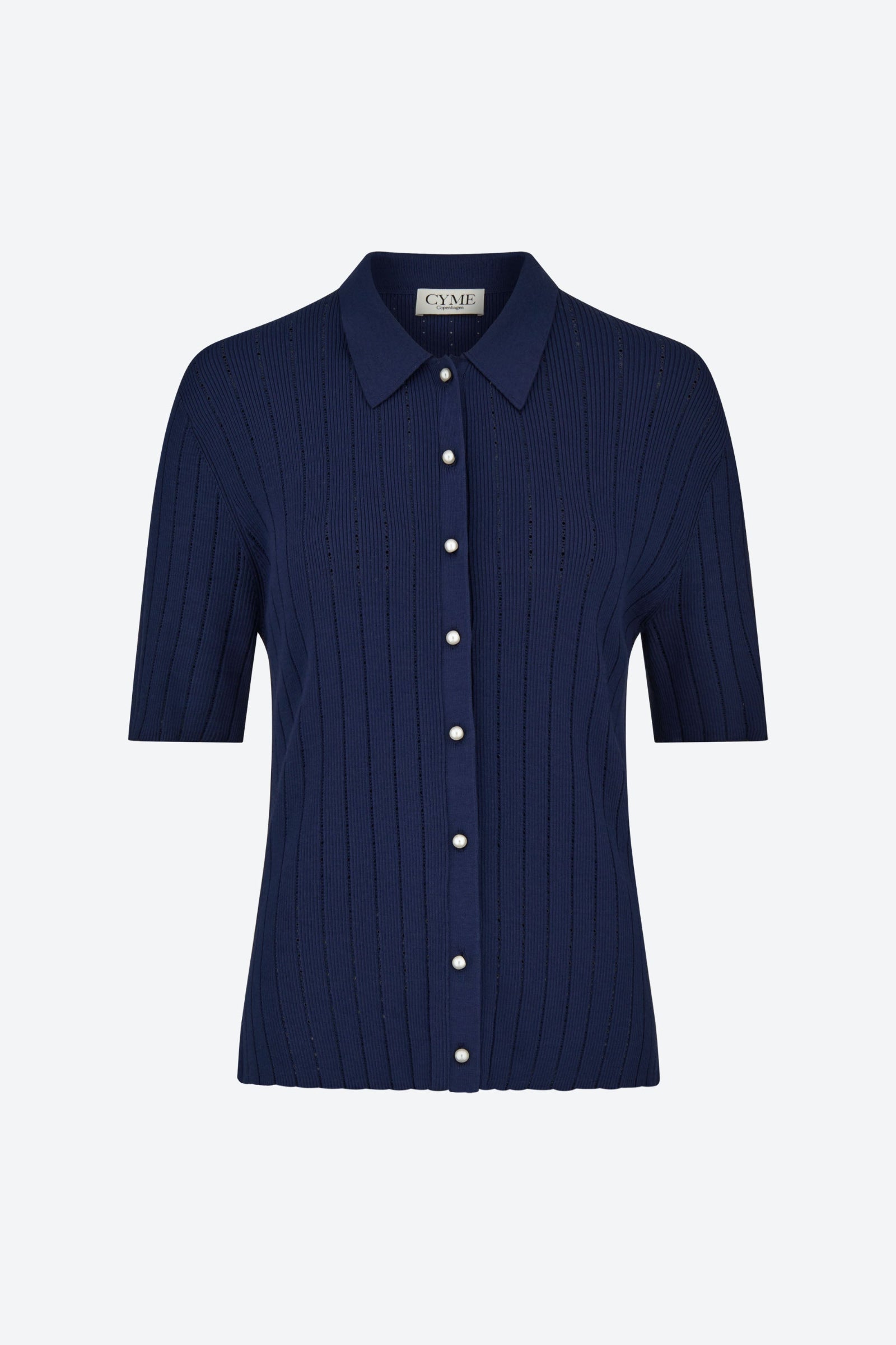 Front view of the CYME Polo Shirt in navy blue with elegant pearl buttons. Crafted from a super soft knit, this fitted silhouette blends refined structure with exceptional comfort.