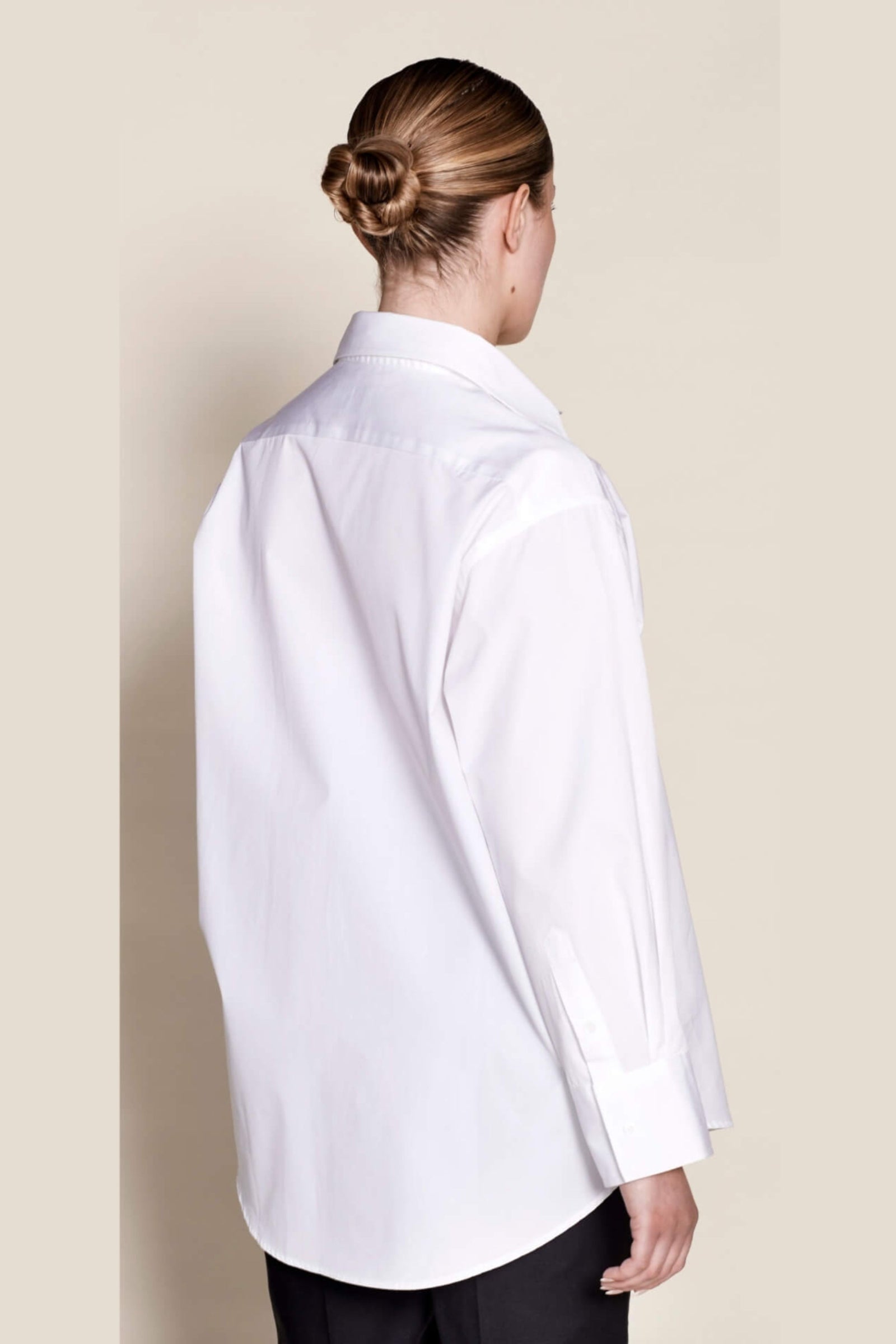 Elegant back view of a Cyme Copenhagen white cotton shirt, highlighting the meticulous design and sustainable fashion ethos of the Danish brand.