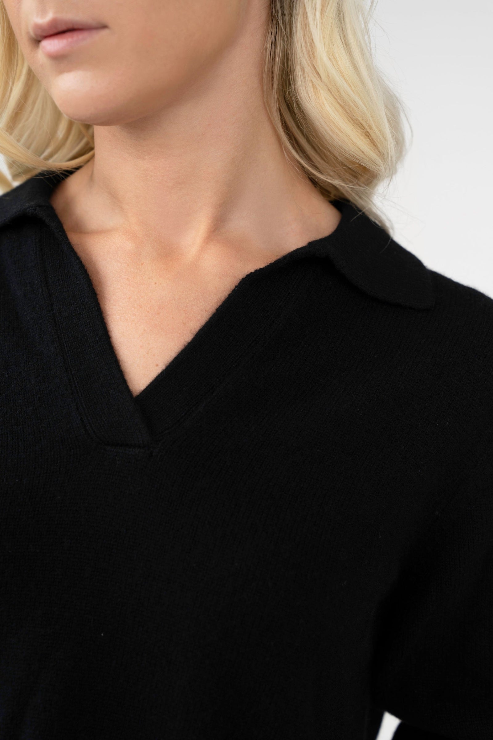 Close-up of a person wearing a black shirt with a blurred background
