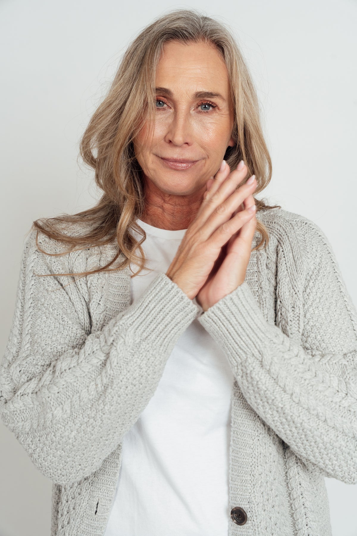 Close-up of the grey Hazel Cable Knit Cardigan's cable-knit sleeves and ribbed cuffs.