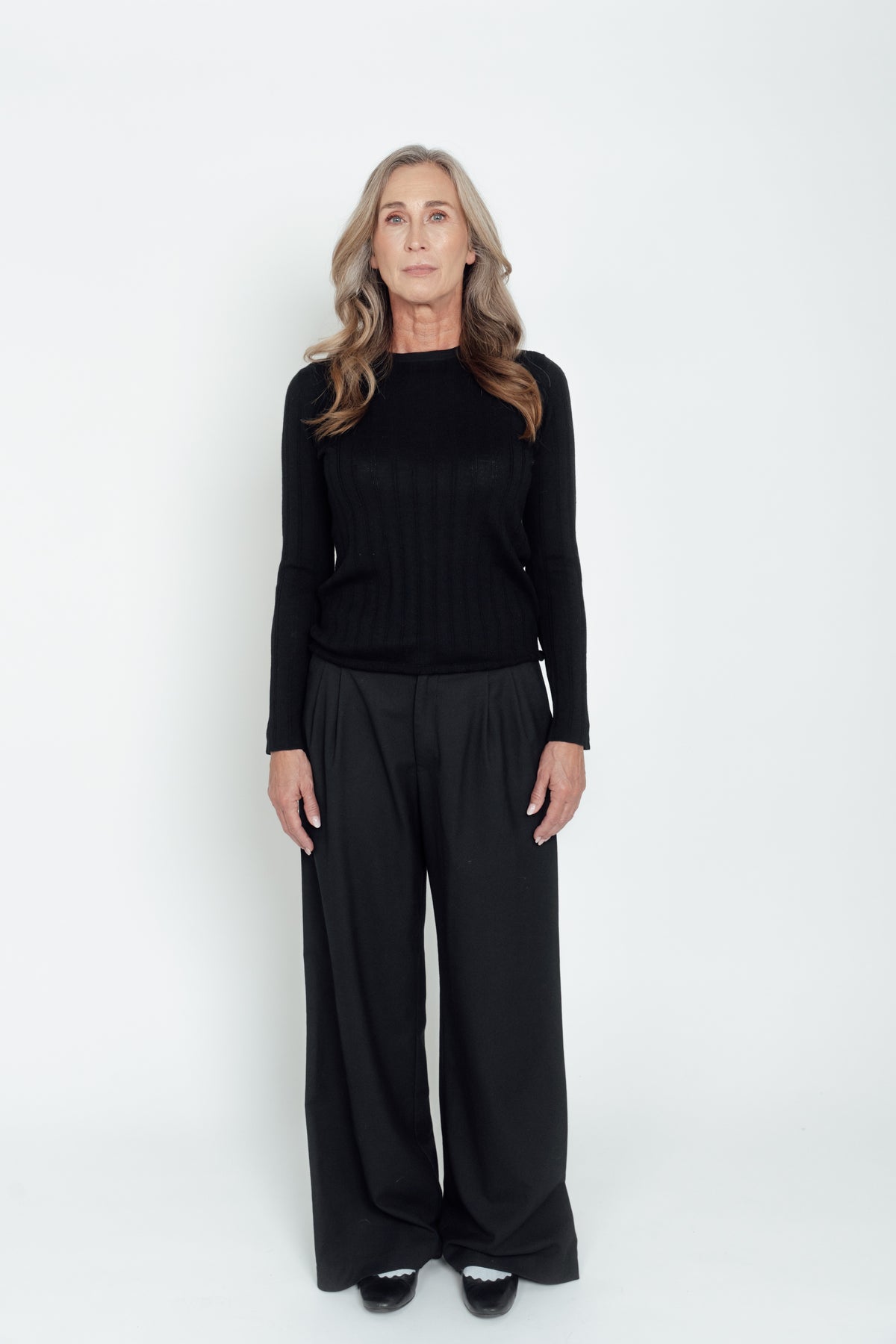 Front view of the black Ivy Merino Top with long sleeves and a round neckline.