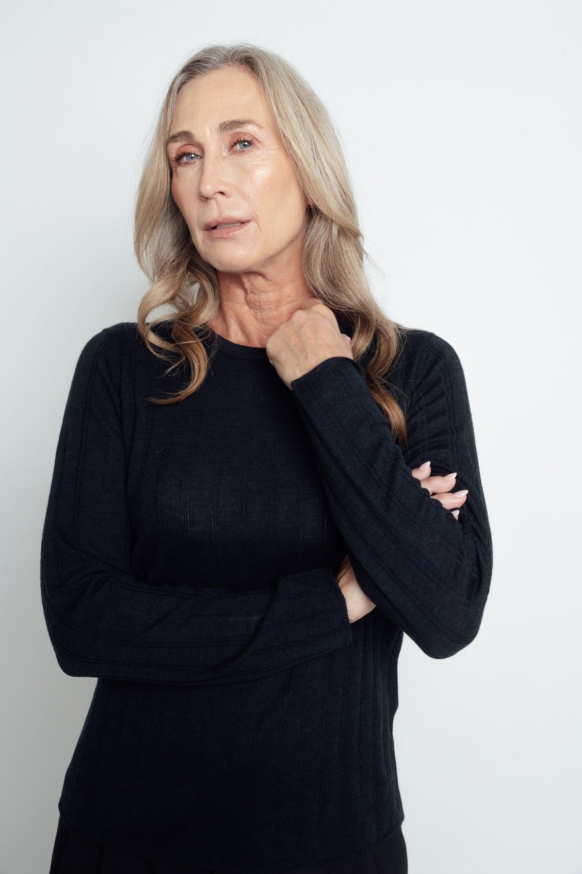 Navy Ivy Merino Top worn with arms folded, showing the round neckline and long sleeves.