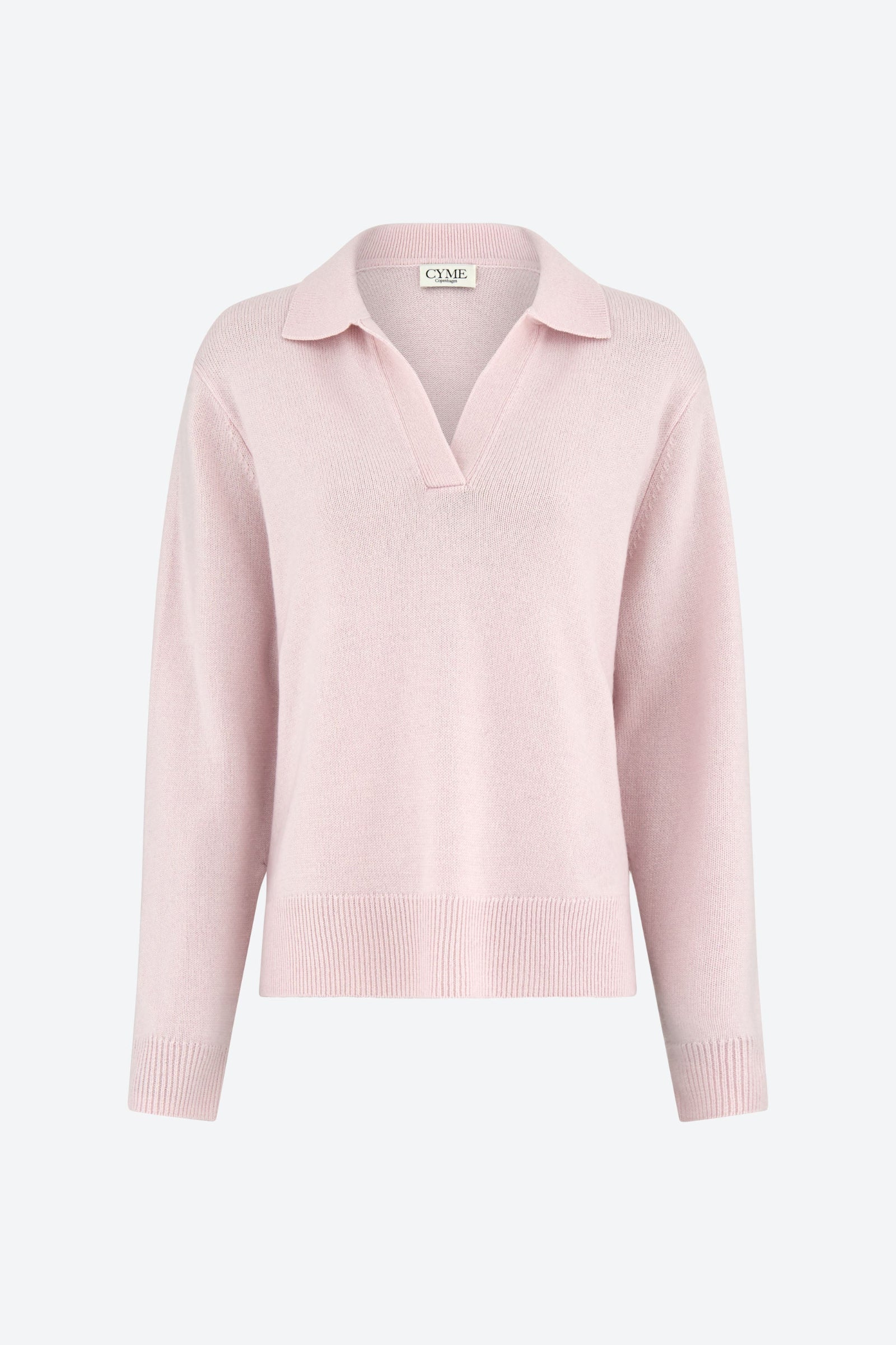 A front view of a light pink polo-style knit jumper with a deep V-neck and long sleeves.