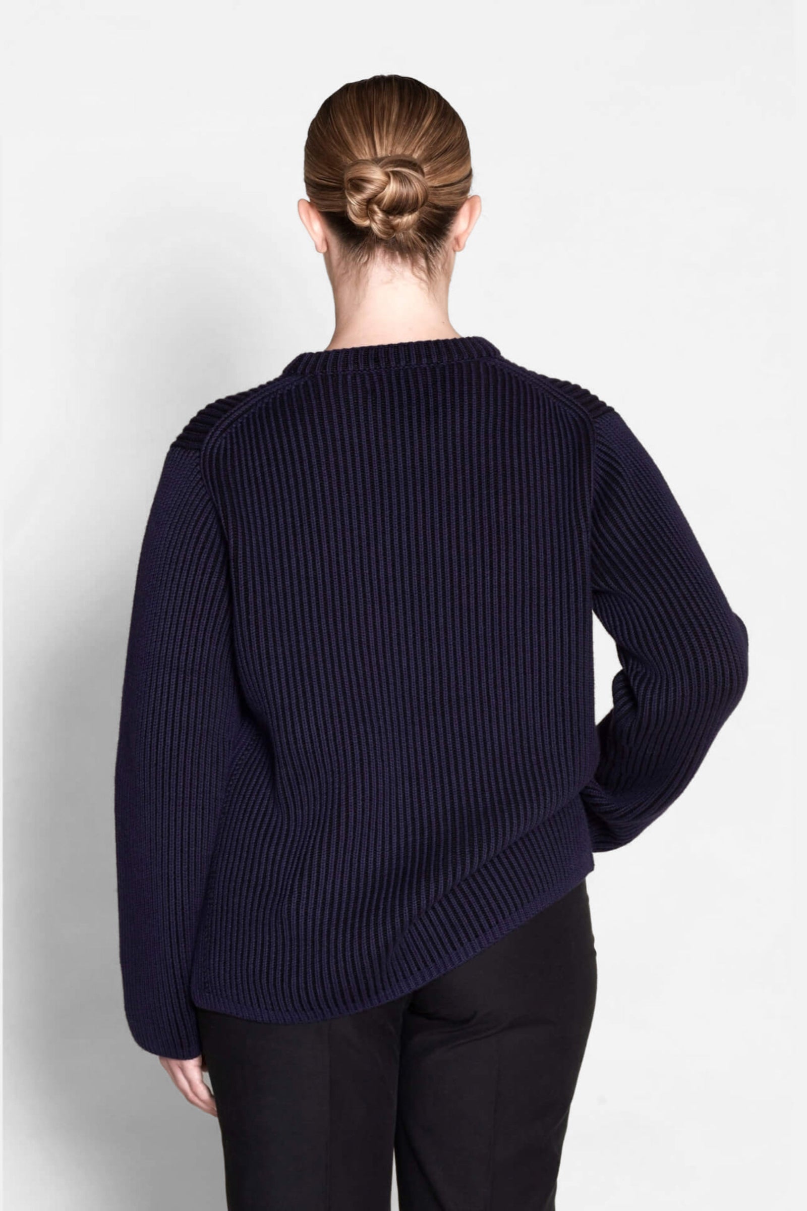 Back view of a Cyme Copenhagen navy ribbed sweater, highlighting the brand's signature knit pattern and quality craftsmanship in sustainable Danish fashion.