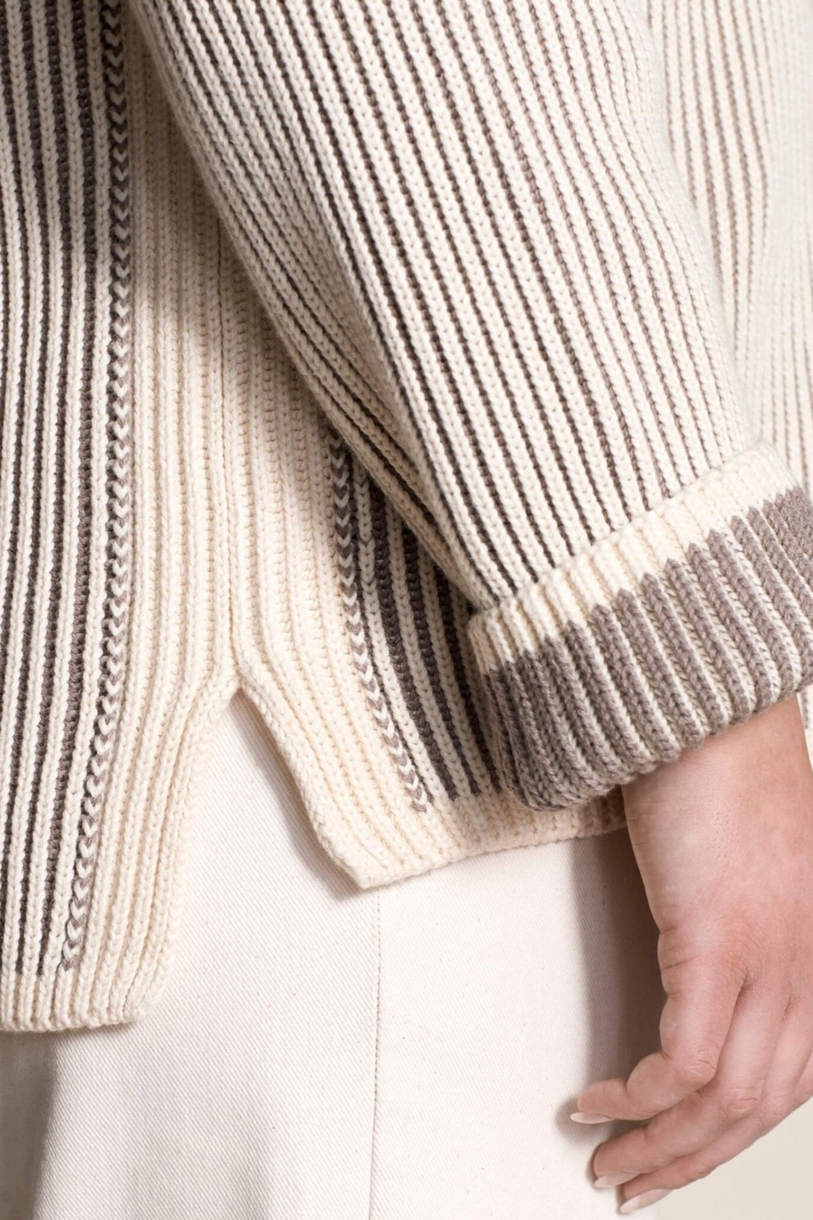 Close-up of the intricate detailing on Cyme Copenhagen's cashmere sweater, highlighting the luxurious natural yarns and meticulous Scandinavian design synonymous with sustainable and classic fashion.
