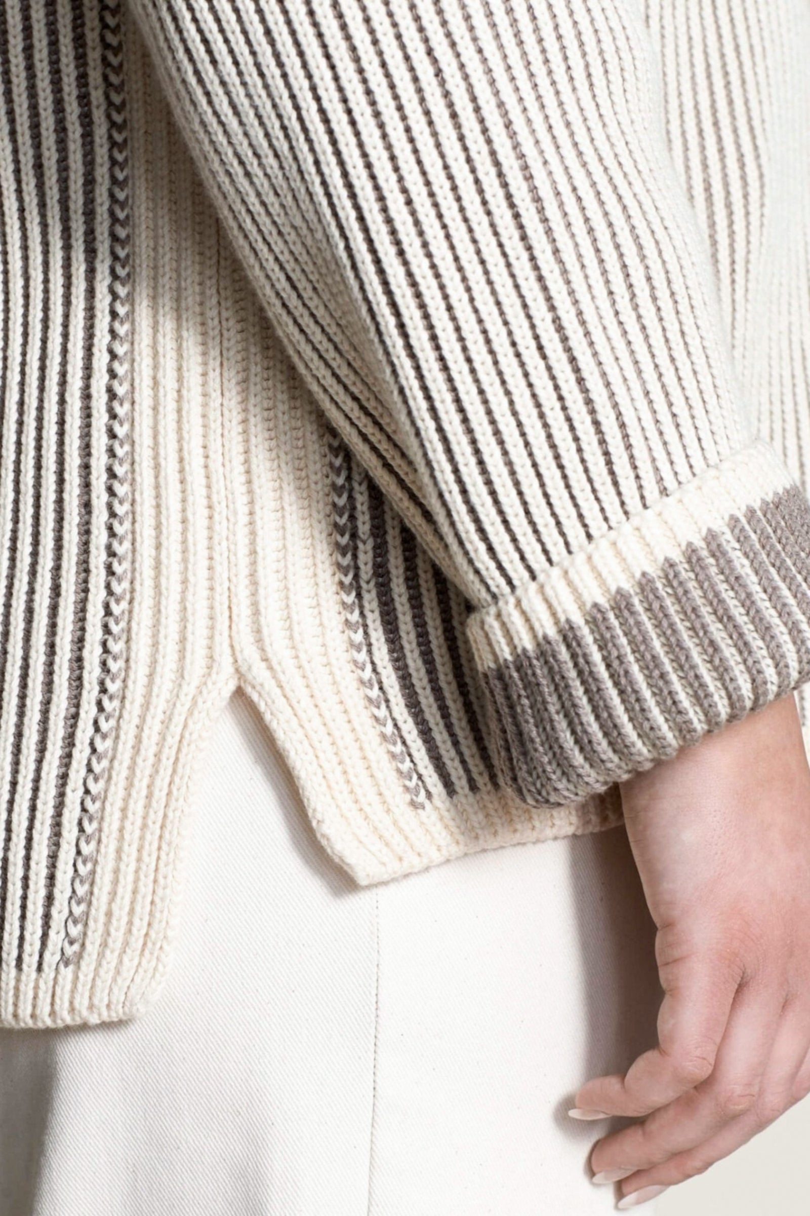 Close-up of the intricate detailing on Cyme Copenhagen's cashmere sweater, highlighting the luxurious natural yarns and meticulous Scandinavian design synonymous with sustainable and classic fashion.