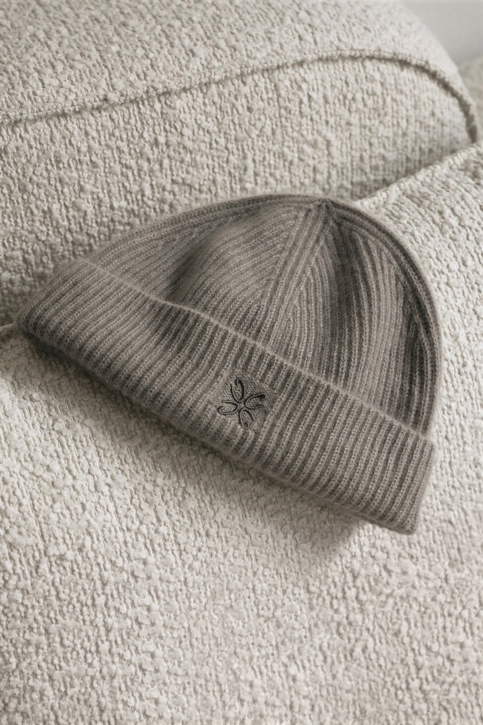 Gray knit beanie with a logo