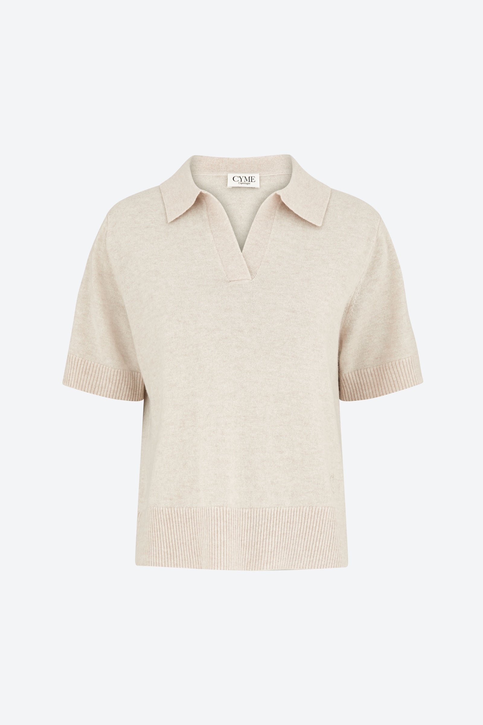 Beige short-sleeve shirt on a light beige background