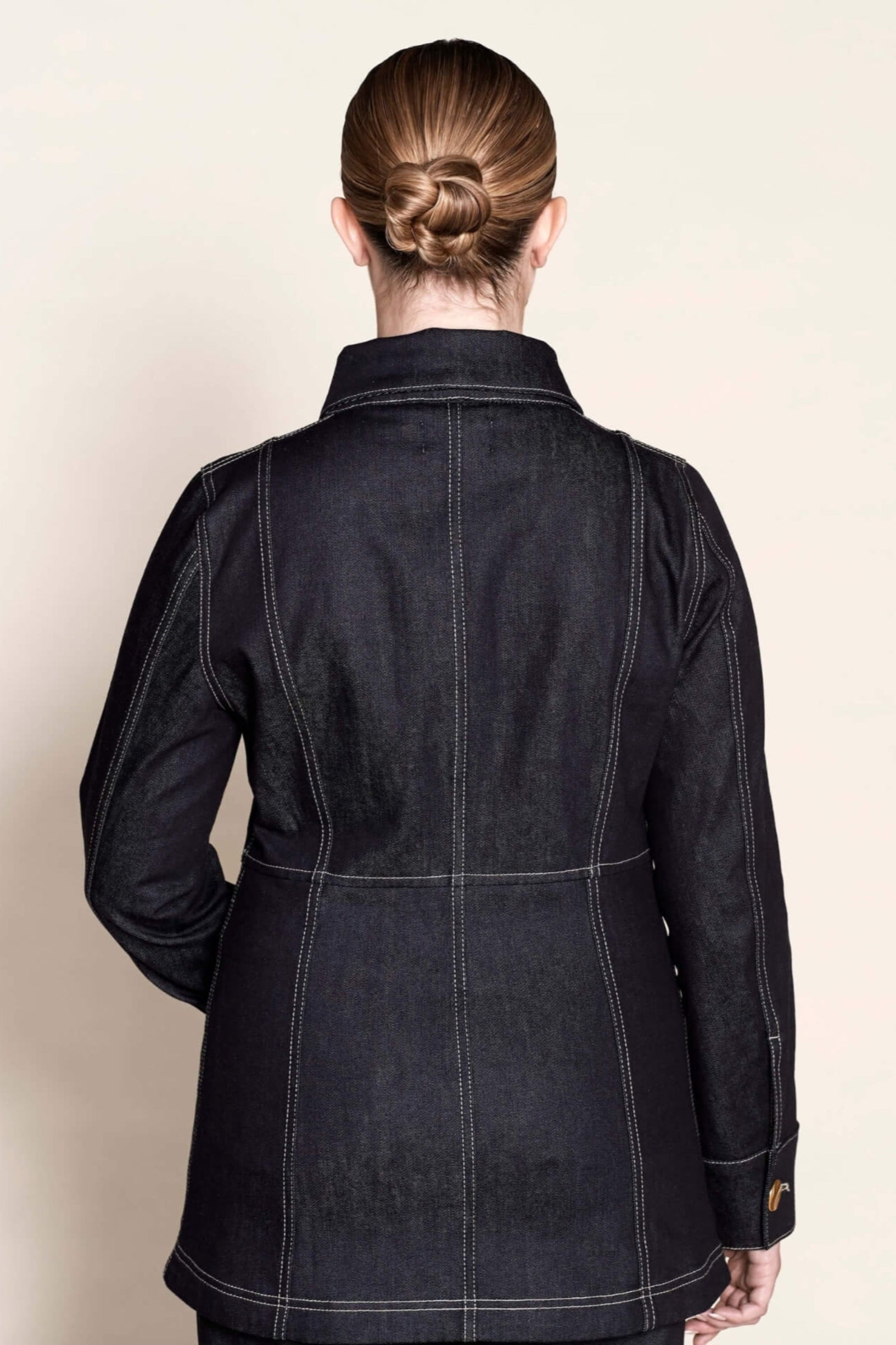 Back view of a tailored Cyme Copenhagen denim jacket, highlighting the fine stitching and structured fit that embody the brand’s Scandinavian design and sustainable fashion ethos.