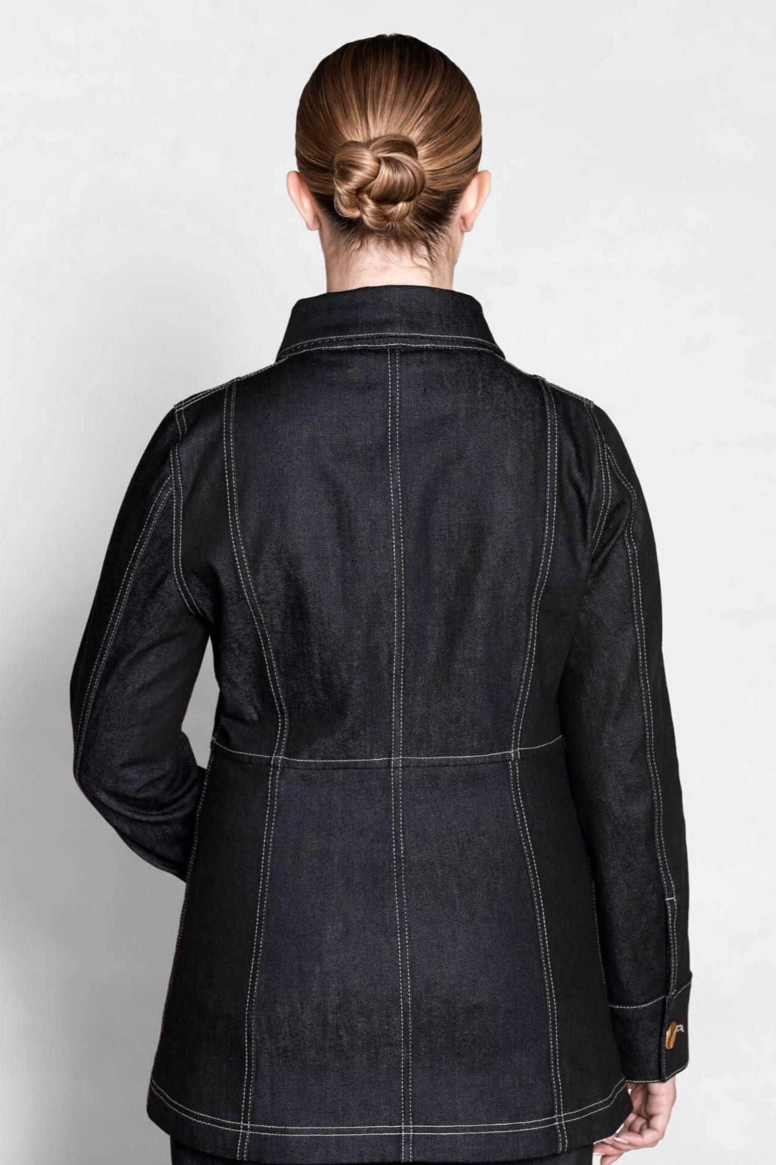 Back view of a tailored Cyme Copenhagen denim jacket, highlighting the fine stitching and structured fit that embody the brand’s Scandinavian design and sustainable fashion ethos.