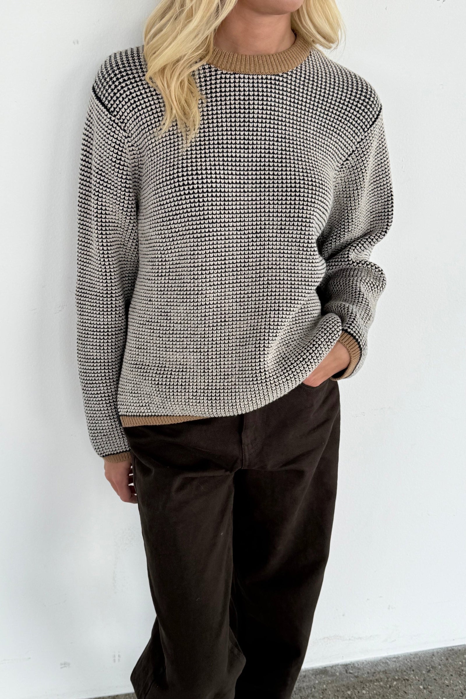 close up picture of waffleknit merino jumper in black, white and taupe.