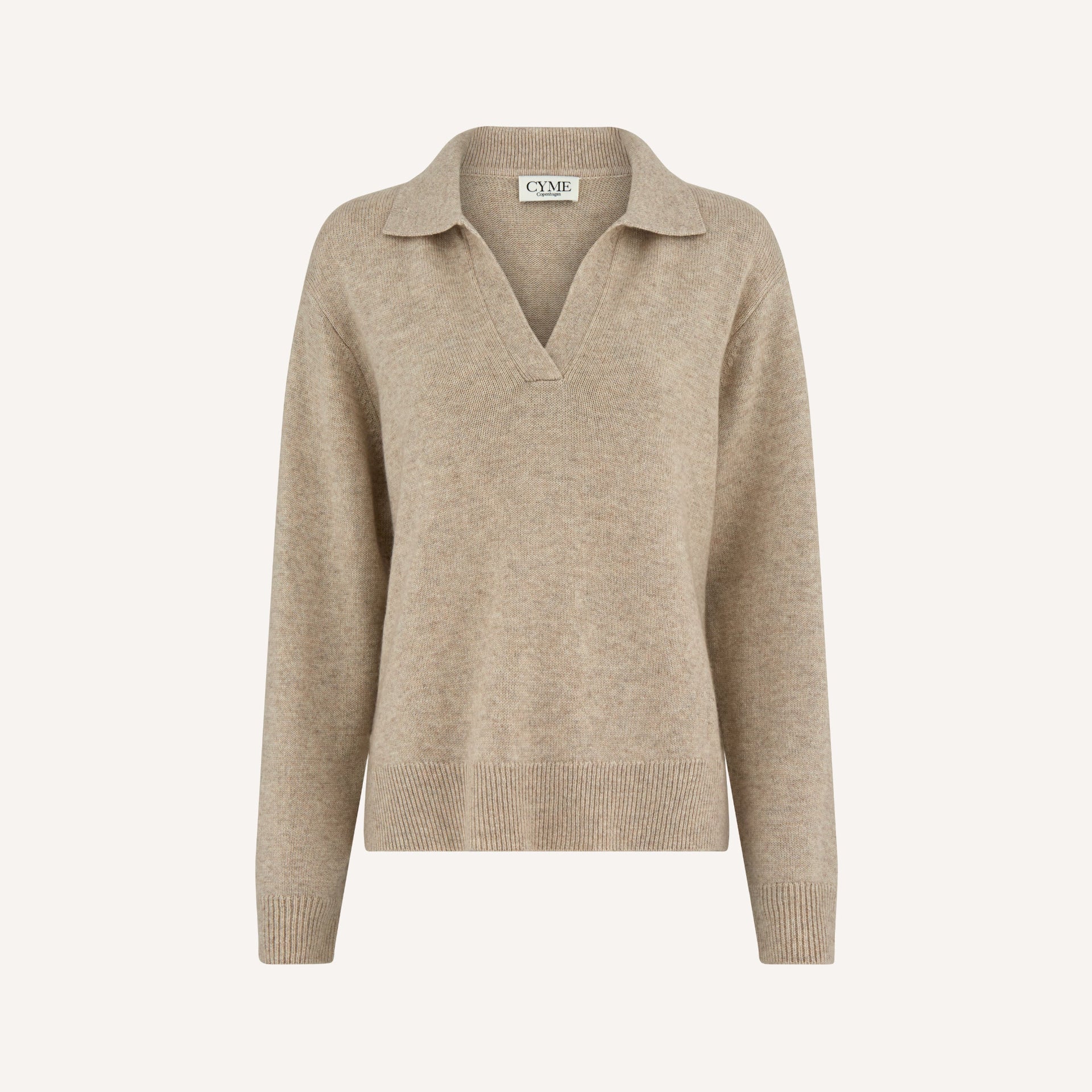 A front view of a beige polo-style knit jumper with a deep V-neck and long sleeves.