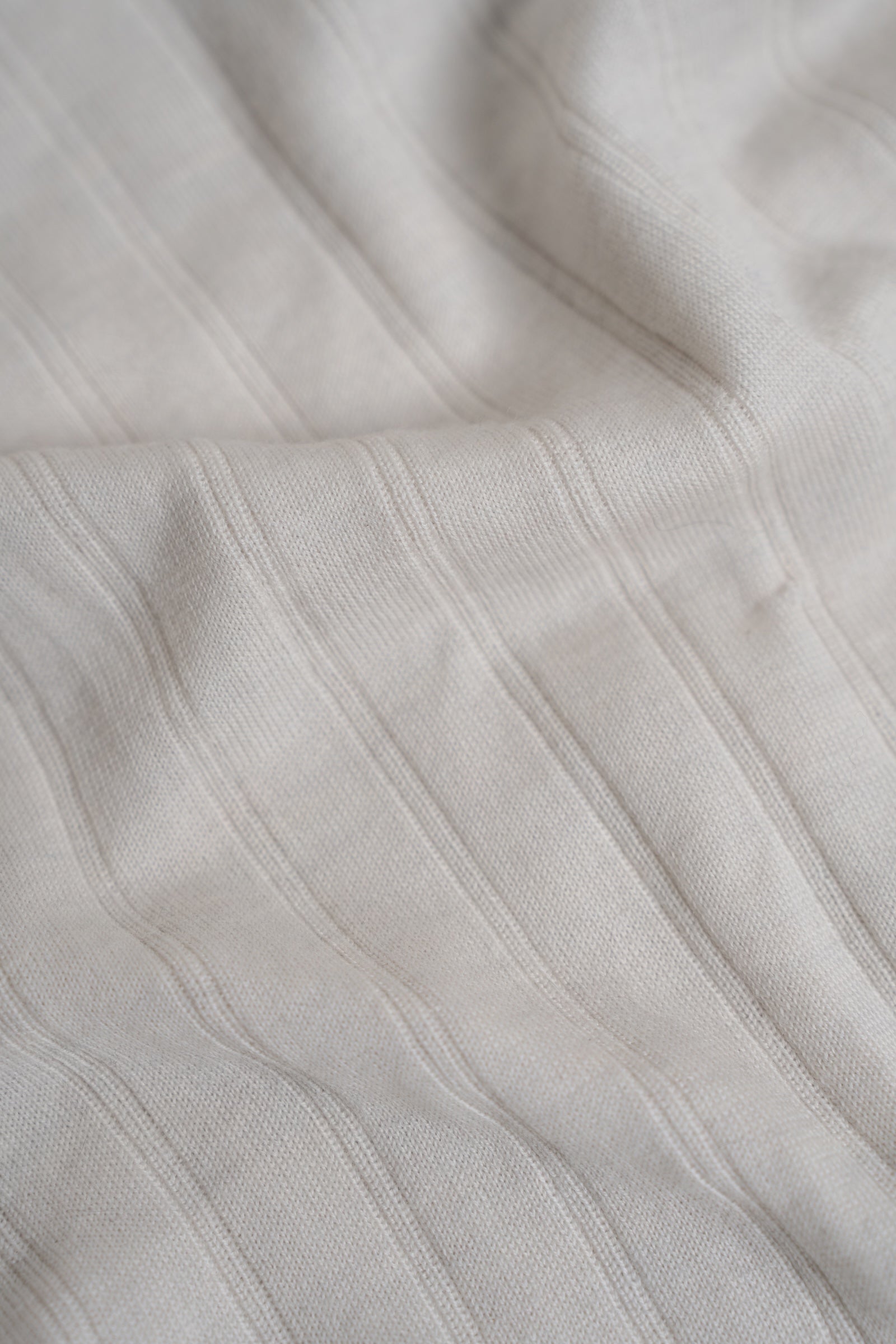 Close-up of light gray fabric with subtle texture