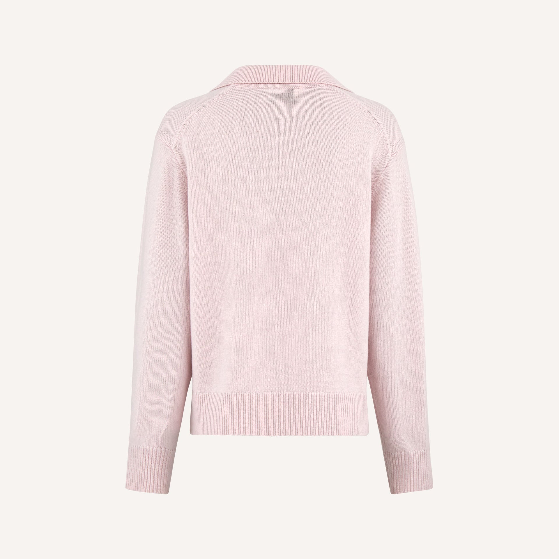 A back view of a light pink polo-style knit jumper with long sleeves and ribbed cuffs.