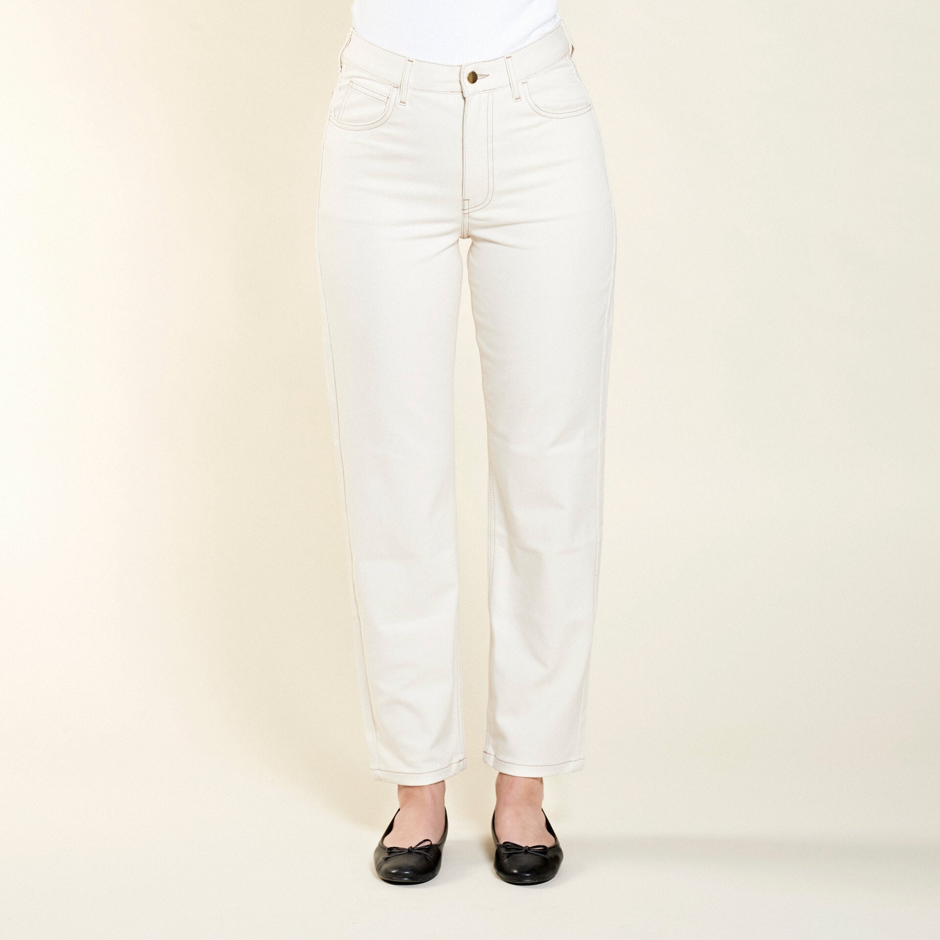 Front view of Cyme Copenhagen's classic cream denim trousers, showcasing the sophisticated cut and sustainable quality materials characteristic of the Danish designer fashion brand.