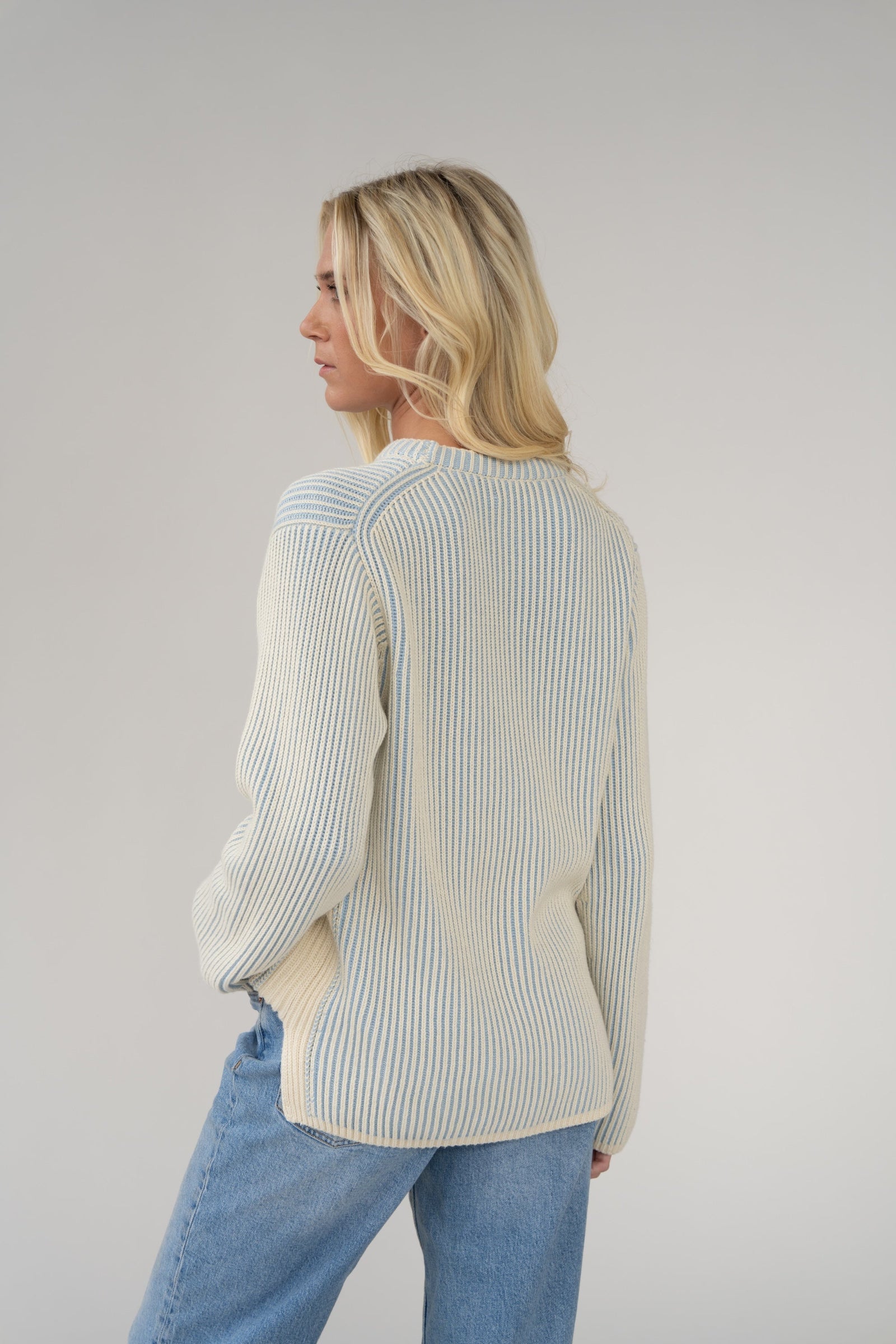 woman wearing a blue and white striped jumper.
