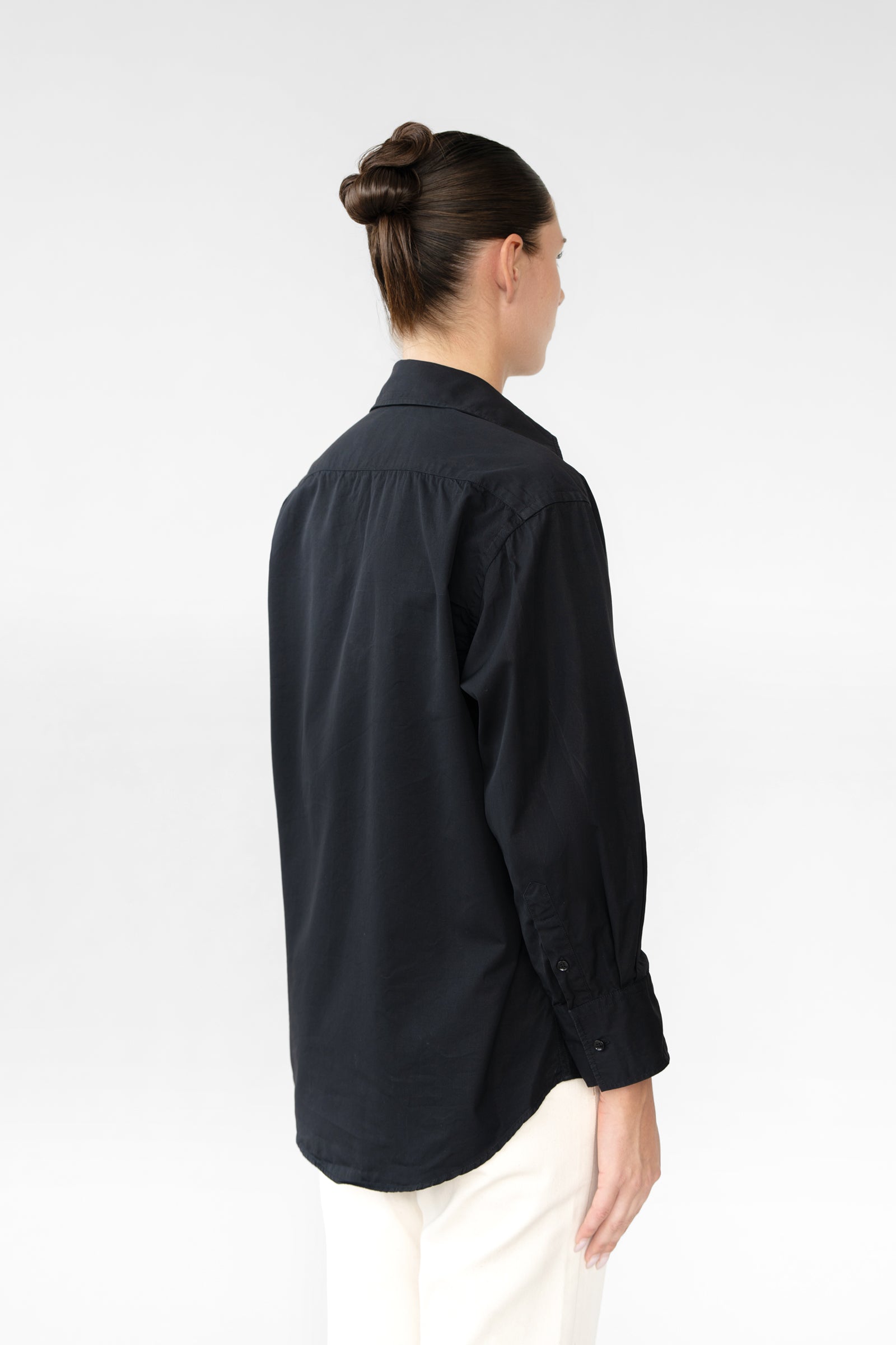 Person wearing a black shirt on a white background