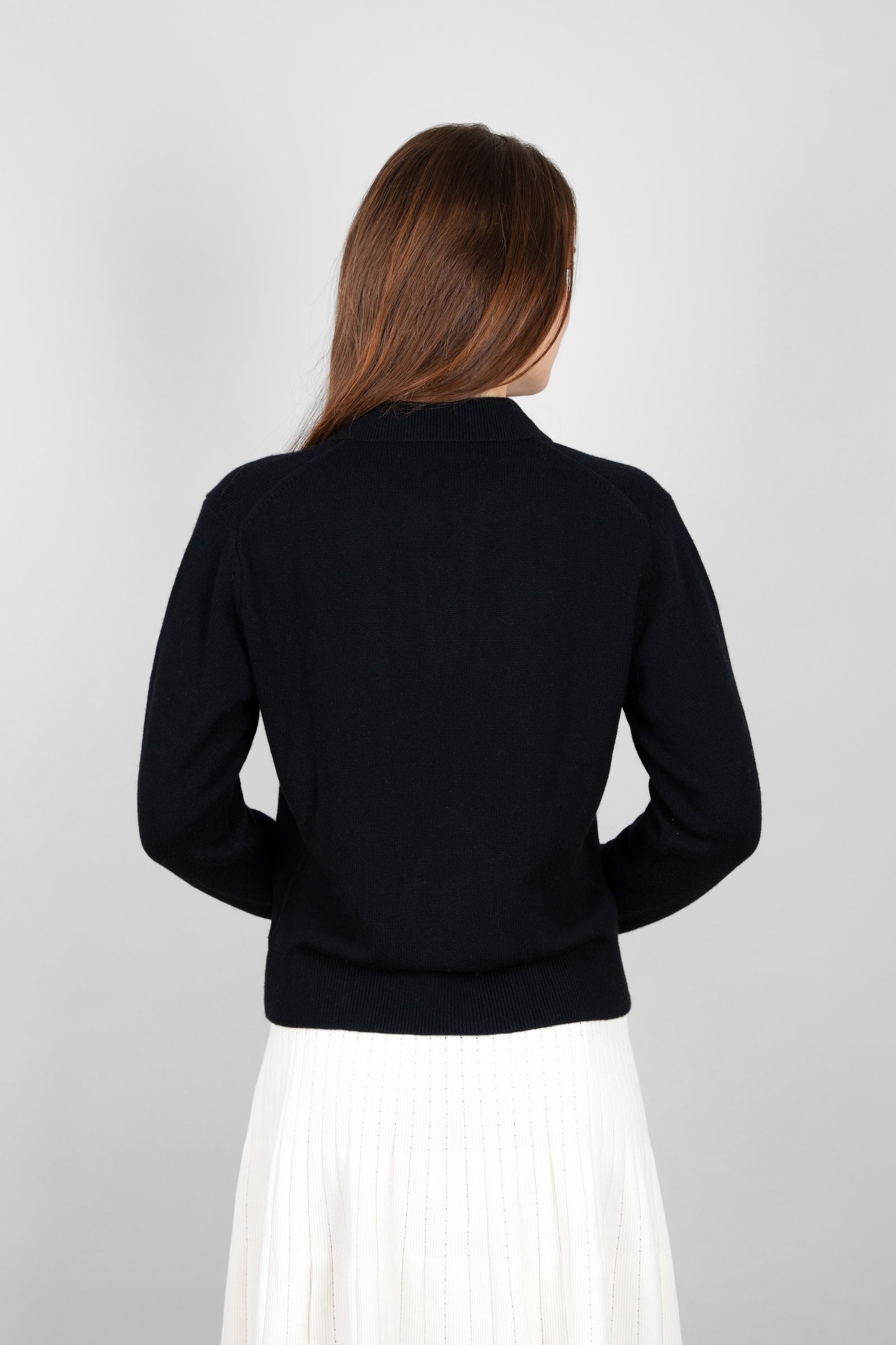 Back view of the CYME Cashmere-Merino Polo Jumper in black, showing the collar and ribbed hem. Crafted in a soft cashmere-merino blend for a relaxed, timeless fit.