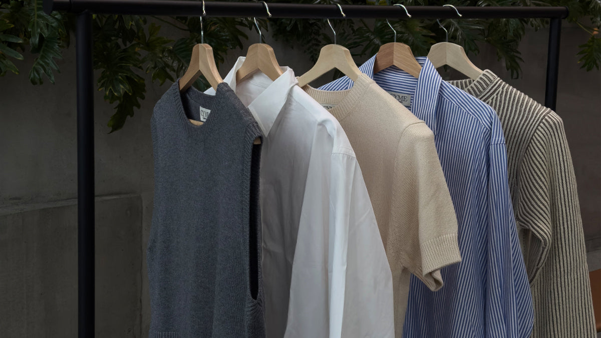 Grey merino vest, Supima shirts in white and stripe, and white Willow &  Cream Cotton cashmere sweater on the clothing rack.