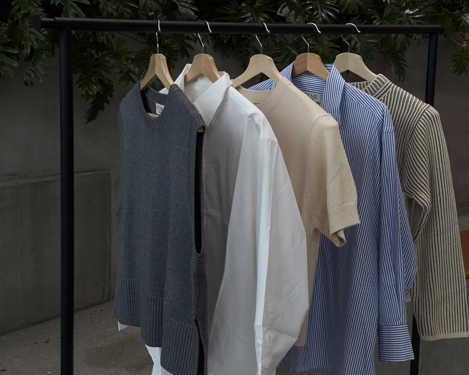 Grey merino vest, Supima shirts in white and stripe, and white Willow &  Cream Cotton cashmere sweater on the clothing rack.