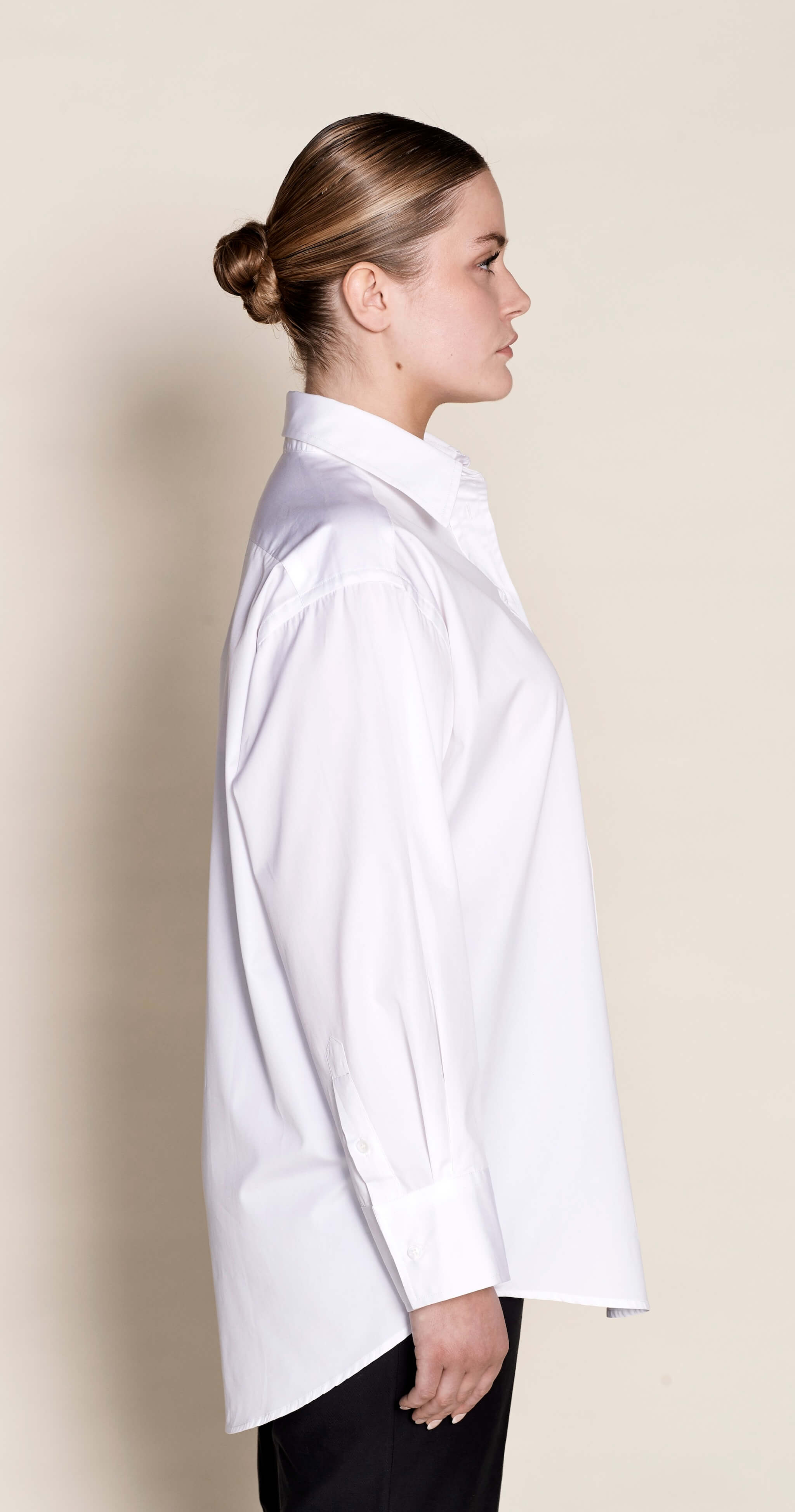 Side profile of a Cyme Copenhagen classic white shirt, displaying the relaxed fit and elegant tailoring that make it a timeless wardrobe essential for sustainable Scandinavian style.