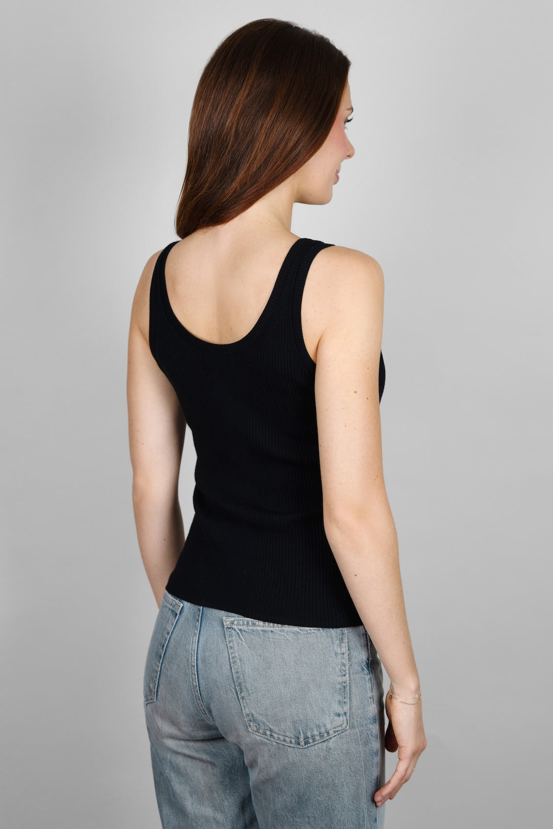 Back view of the CYME Essential Top in black, showing the scoop back and fitted ribbed knit. Crafted in a soft, stretchy fabric for a timeless, easy fit.