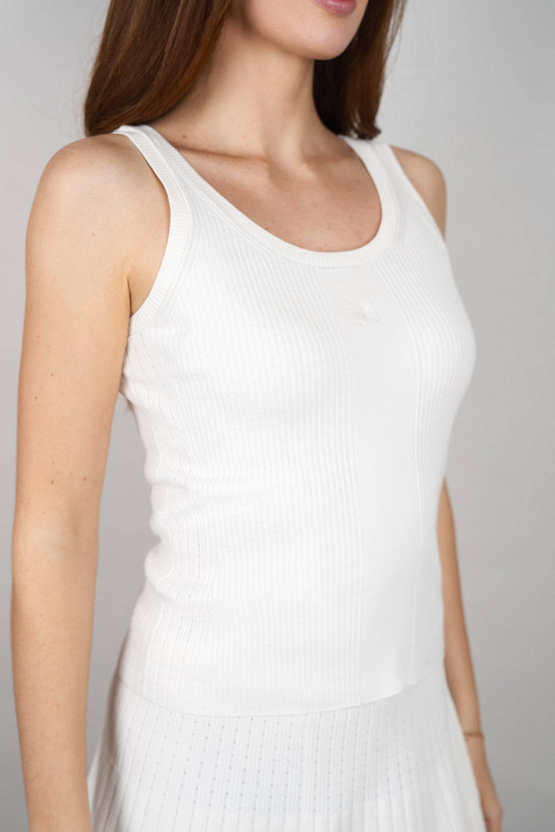 Close-up front view of the CYME Essential Top in ivory, highlighting the scoop neckline, ribbed texture and tonal CYME logo. Crafted in an ultra-soft knit with stretch.