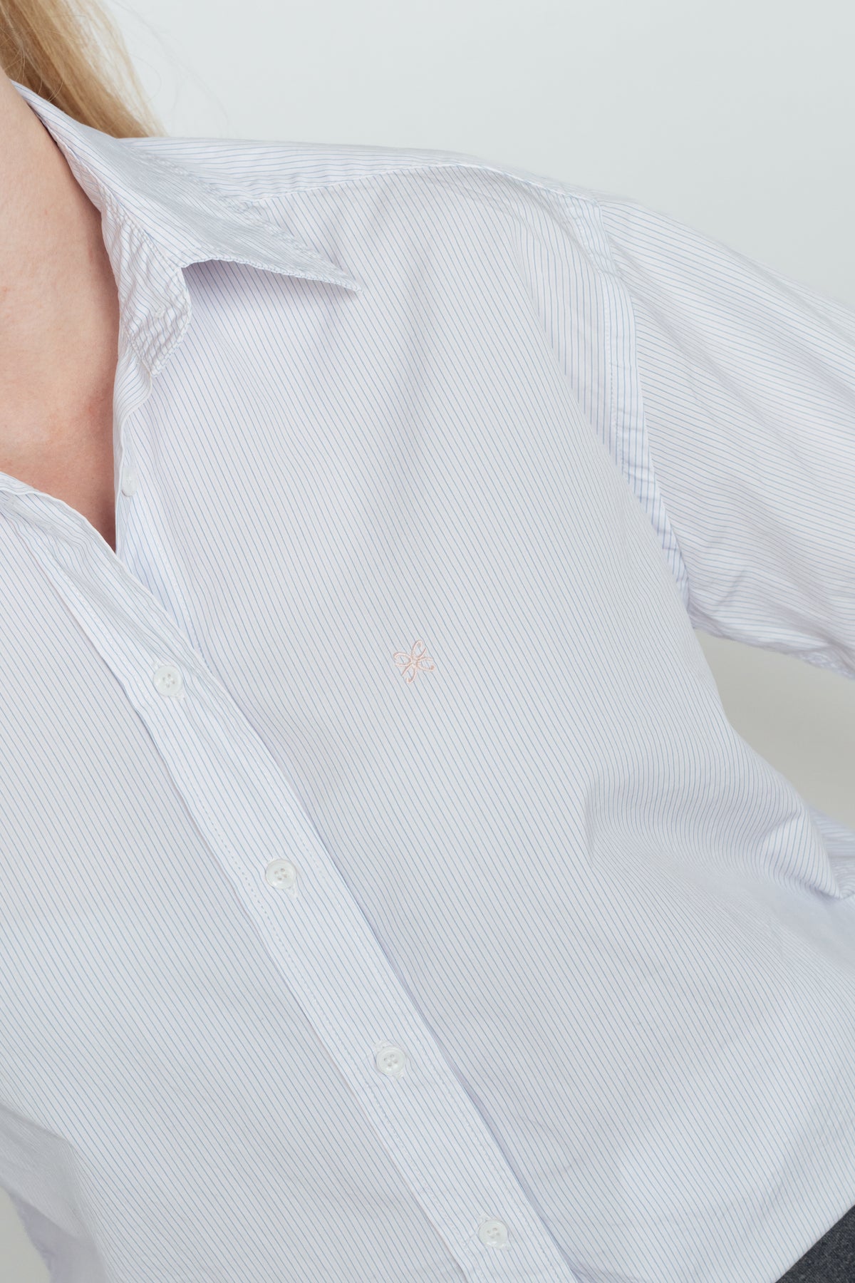 Close-up of the Light Blue & Pink Cyme Supima Shirt's fine stripes, collar and pink embroidered logo.