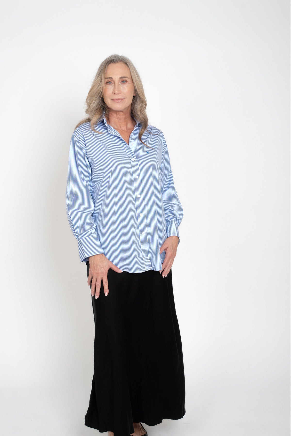Full-length front view of the blue-and-white striped Cyme Supima Shirt worn untucked.