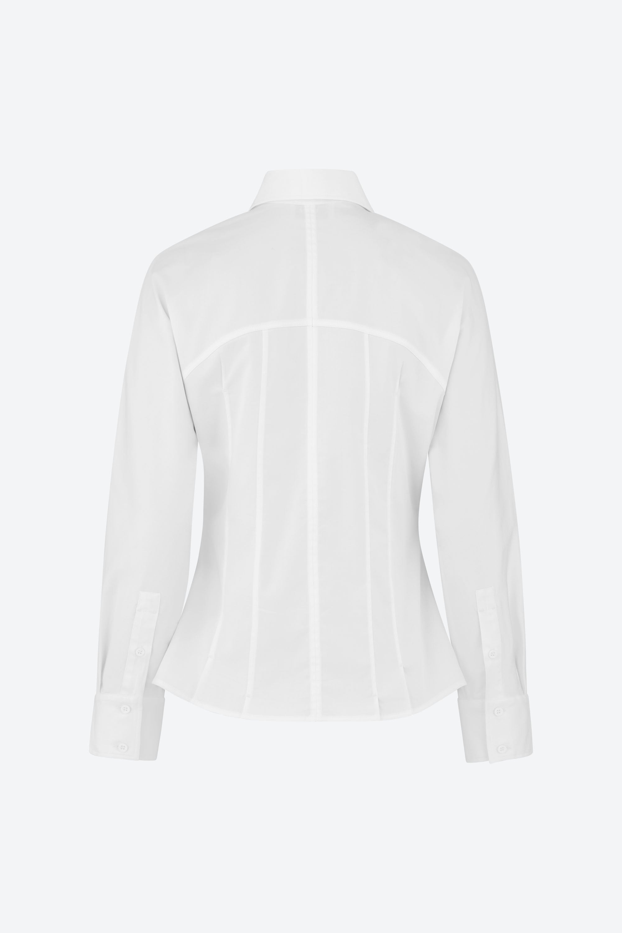 Back view of a white, long-sleeve, tailored shirt with a pointed collar. The shirt features vertical seams that enhance the fit and has a structured design, displayed on a plain background.