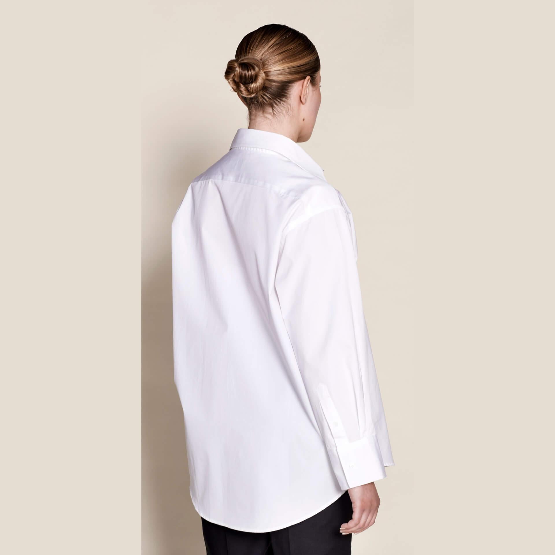 Elegant back view of a Cyme Copenhagen white cotton shirt, highlighting the meticulous design and sustainable fashion ethos of the Danish brand.