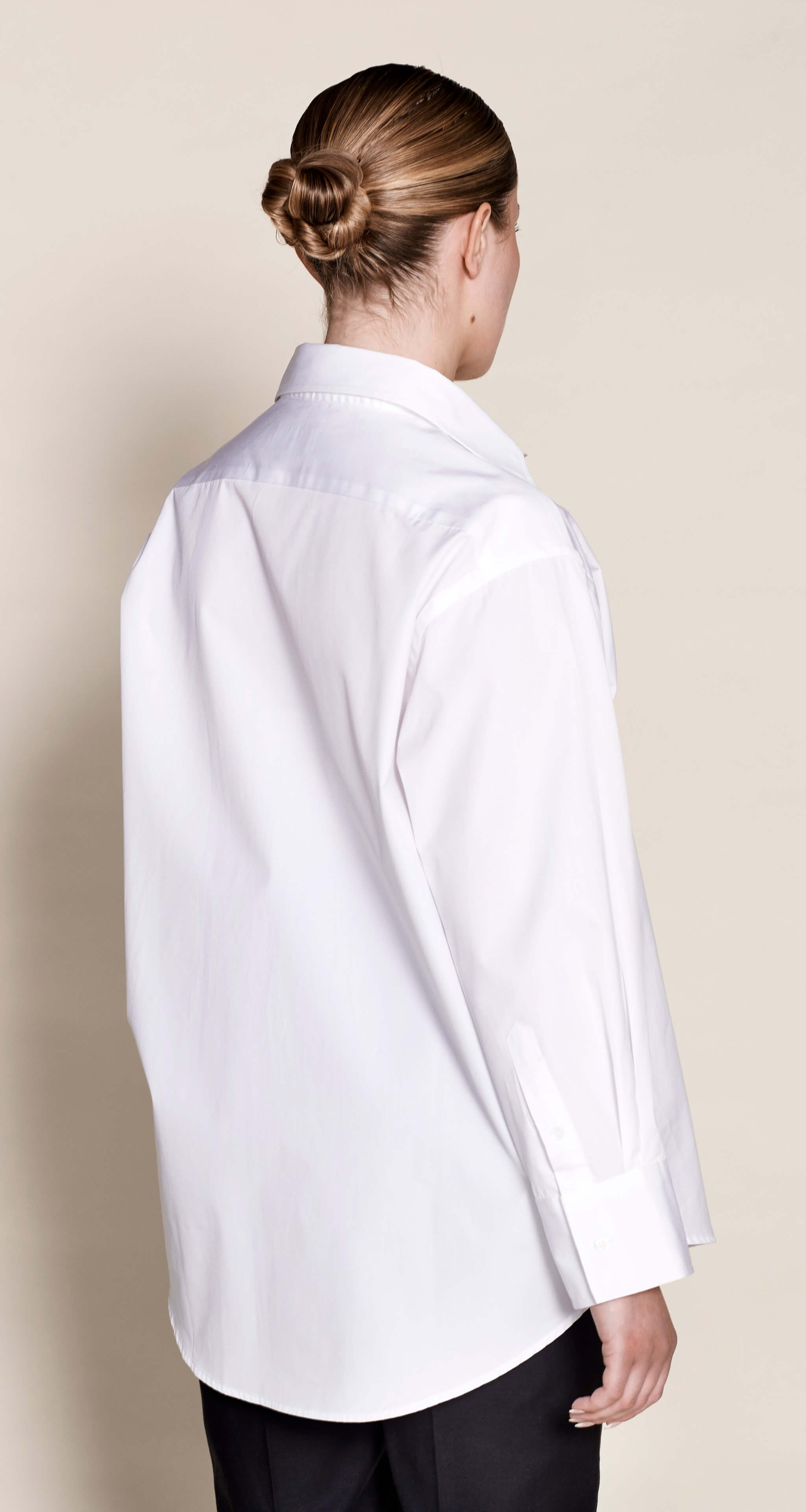 Elegant back view of a Cyme Copenhagen white cotton shirt, highlighting the meticulous design and sustainable fashion ethos of the Danish brand.