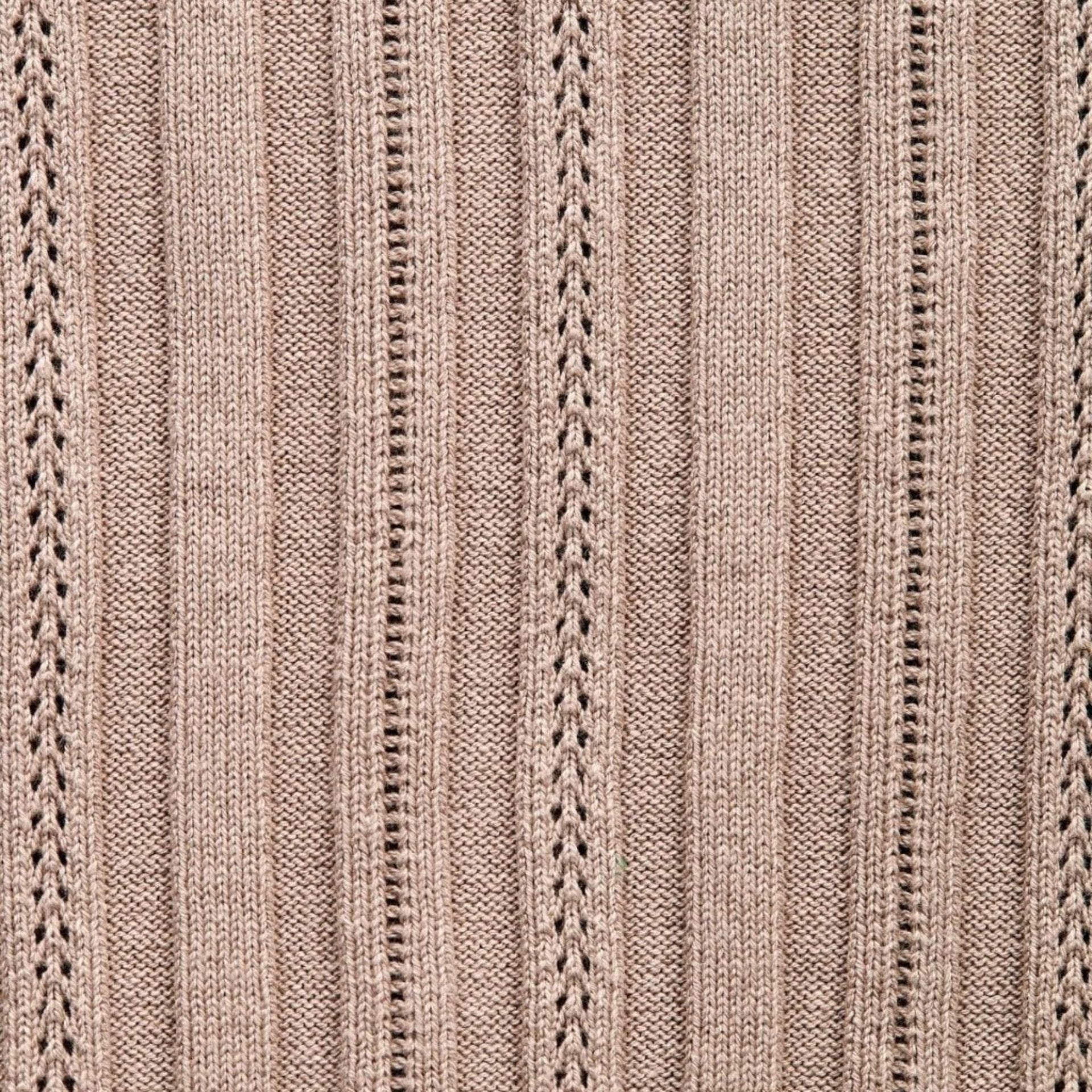 Close-up of the intricate knit pattern on a taupe garment, showcasing Cyme Copenhagen's attention to detail and craftsmanship in sustainable materials for their Danish fashion brand, specializing in women's clothing.