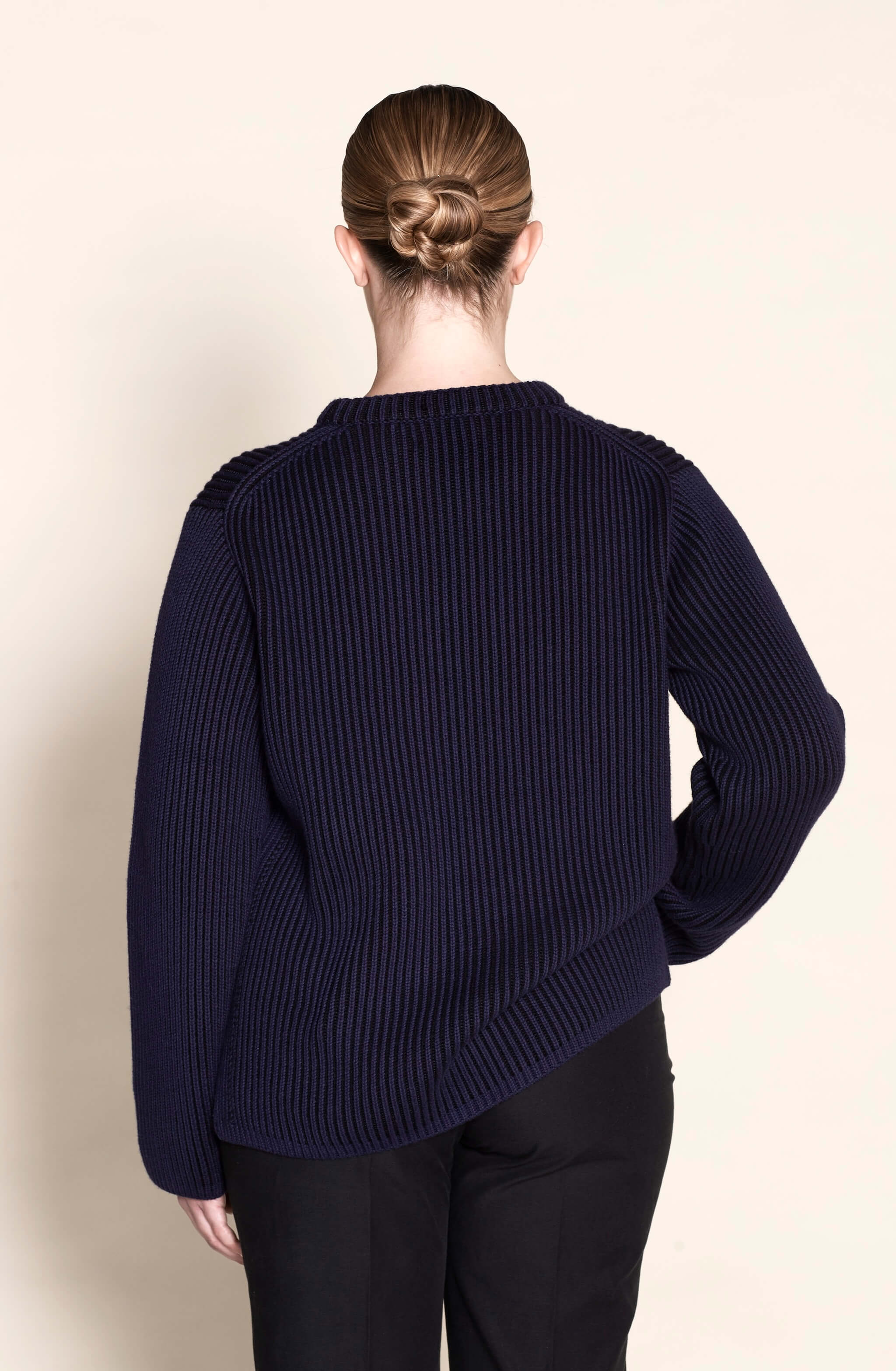 Back view of a Cyme Copenhagen navy ribbed sweater, highlighting the brand's signature knit pattern and quality craftsmanship in sustainable Danish fashion.