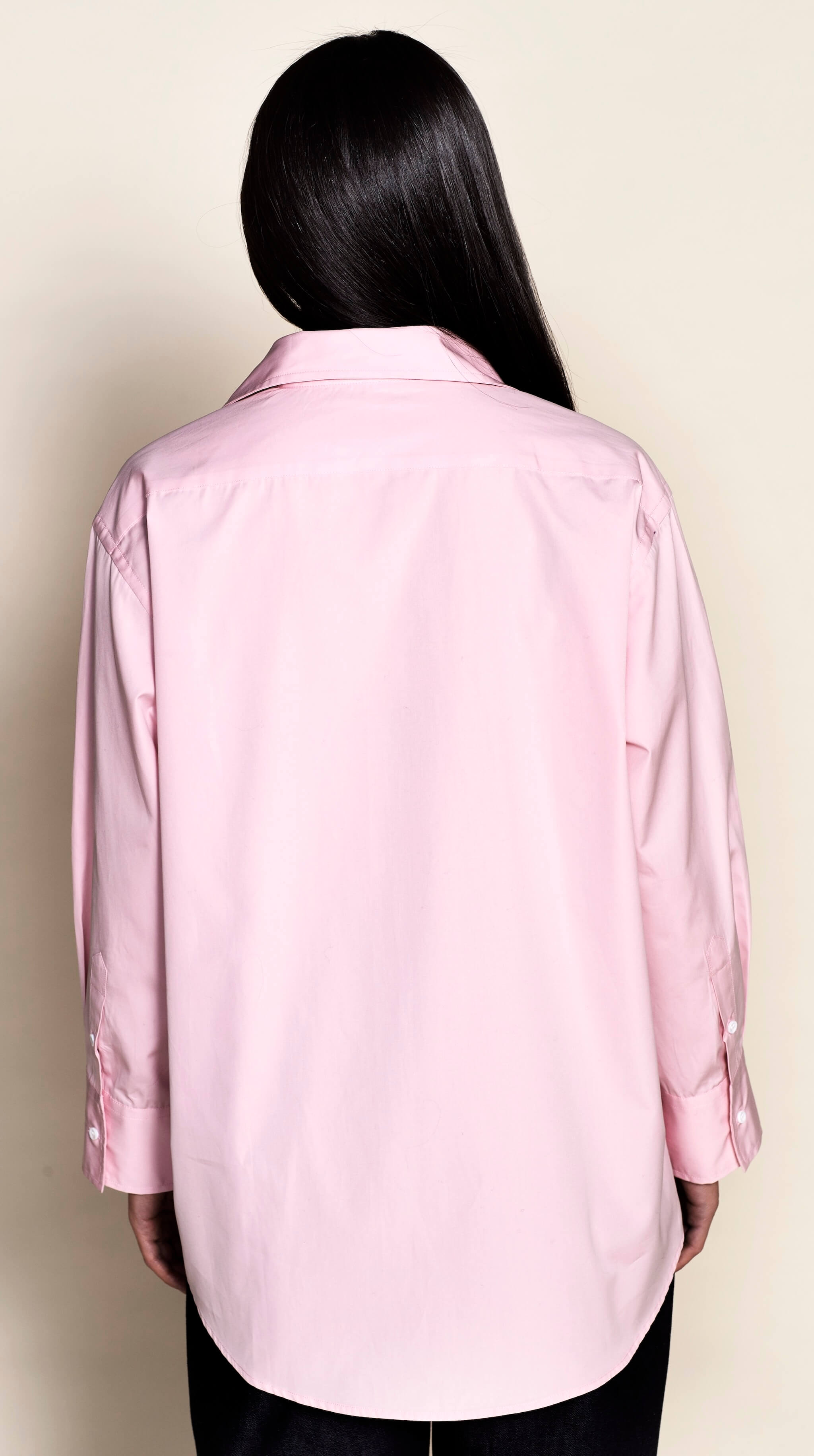 Close-up of a delicate pink supima cotton shirt with the Cyme Copenhagen label, exemplifying the brand's use of premium materials and sustainable fashion in creating stylish women's clothes by a Danish designer.