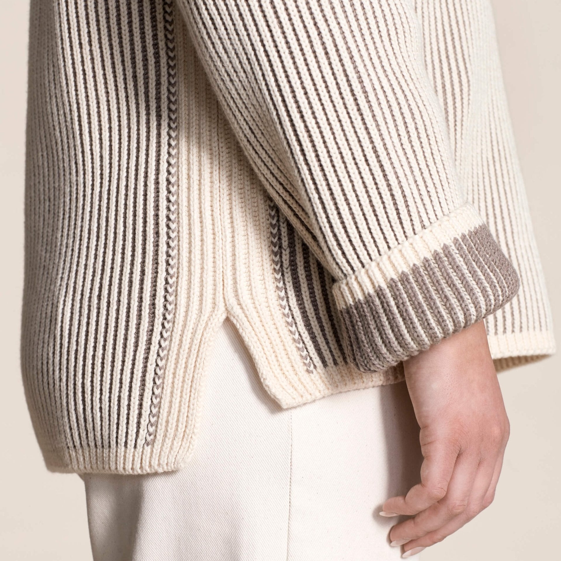 Close-up of the intricate detailing on Cyme Copenhagen's cashmere sweater, highlighting the luxurious natural yarns and meticulous Scandinavian design synonymous with sustainable and classic fashion.