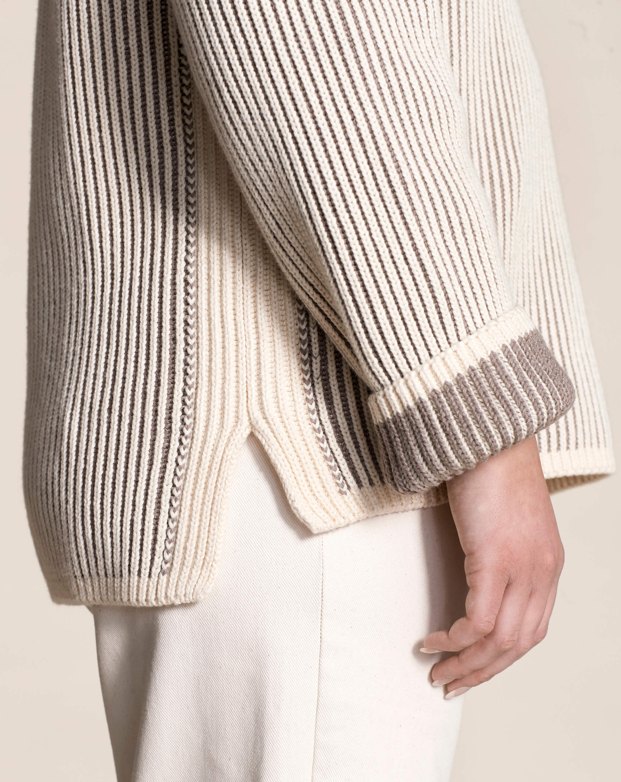 Close-up of the intricate detailing on Cyme Copenhagen's cashmere sweater, highlighting the luxurious natural yarns and meticulous Scandinavian design synonymous with sustainable and classic fashion.
