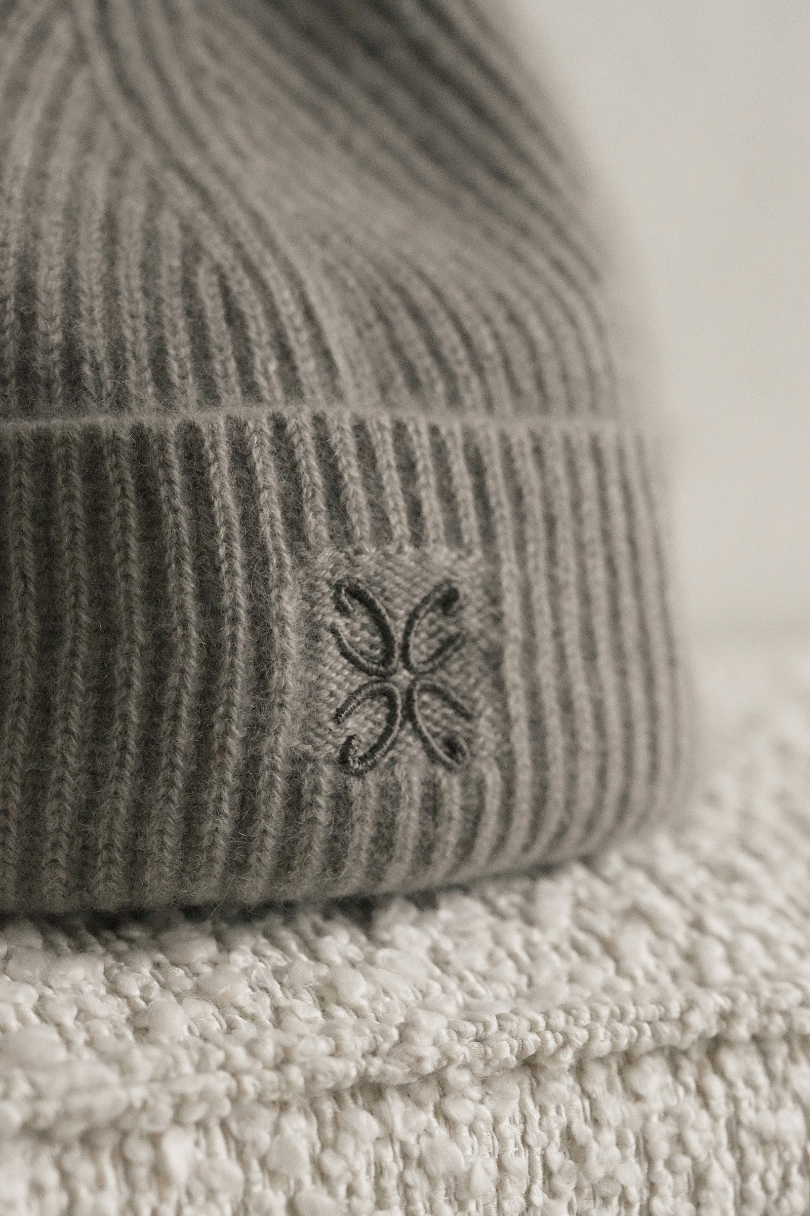 Gray knit beanie with a logo