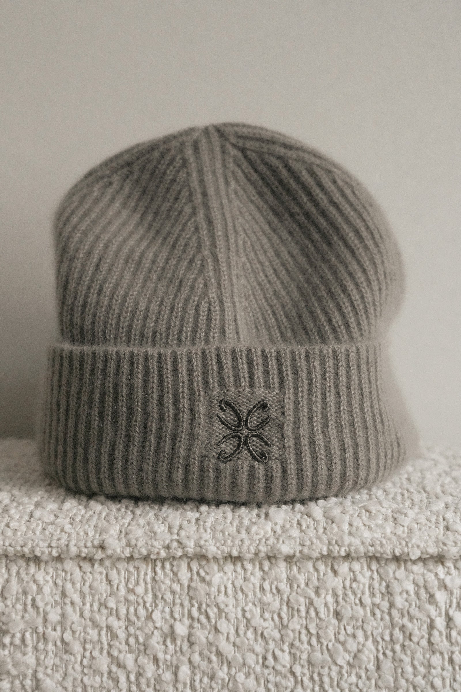 Gray knit beanie with a logo