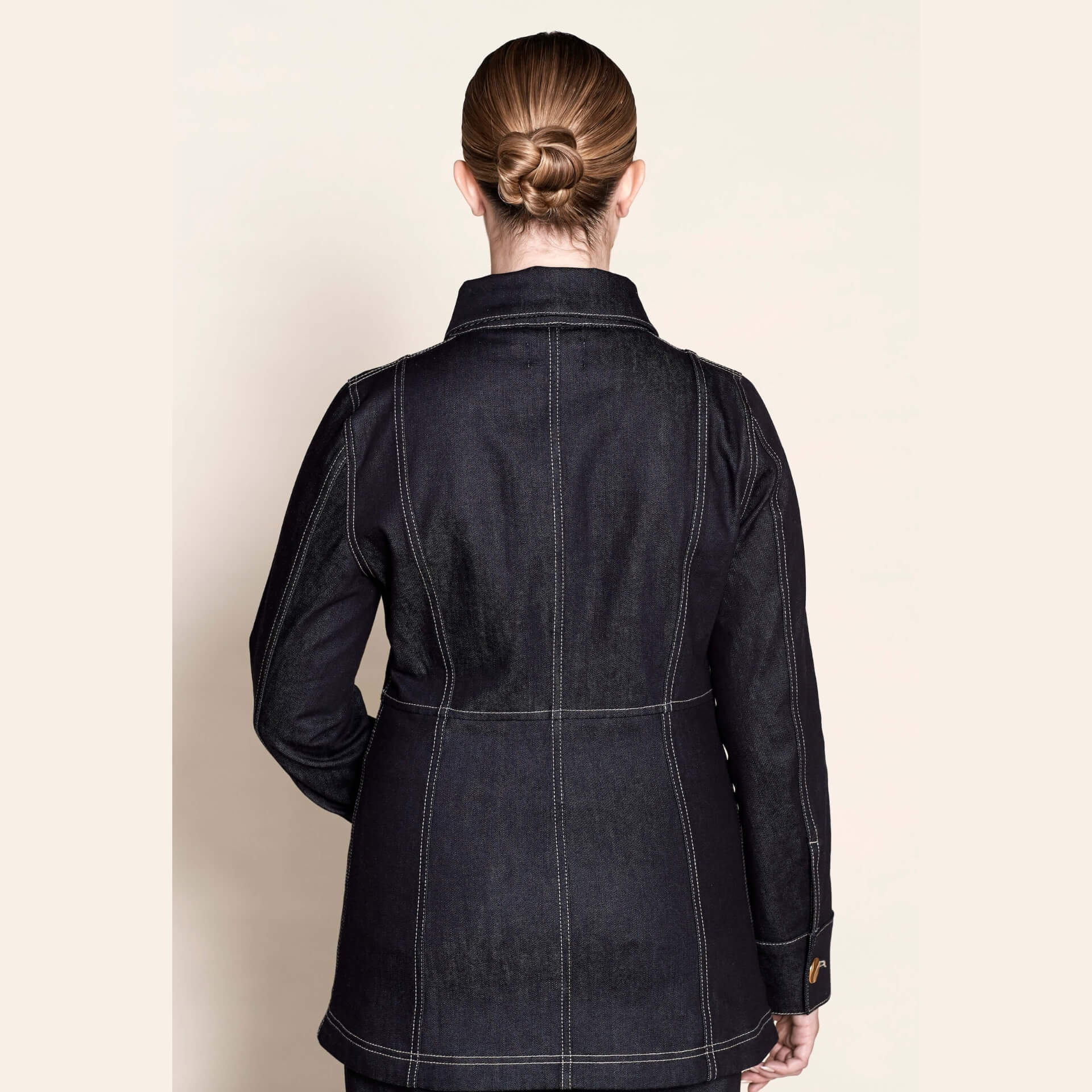 Back view of a tailored Cyme Copenhagen denim jacket, highlighting the fine stitching and structured fit that embody the brand’s Scandinavian design and sustainable fashion ethos.