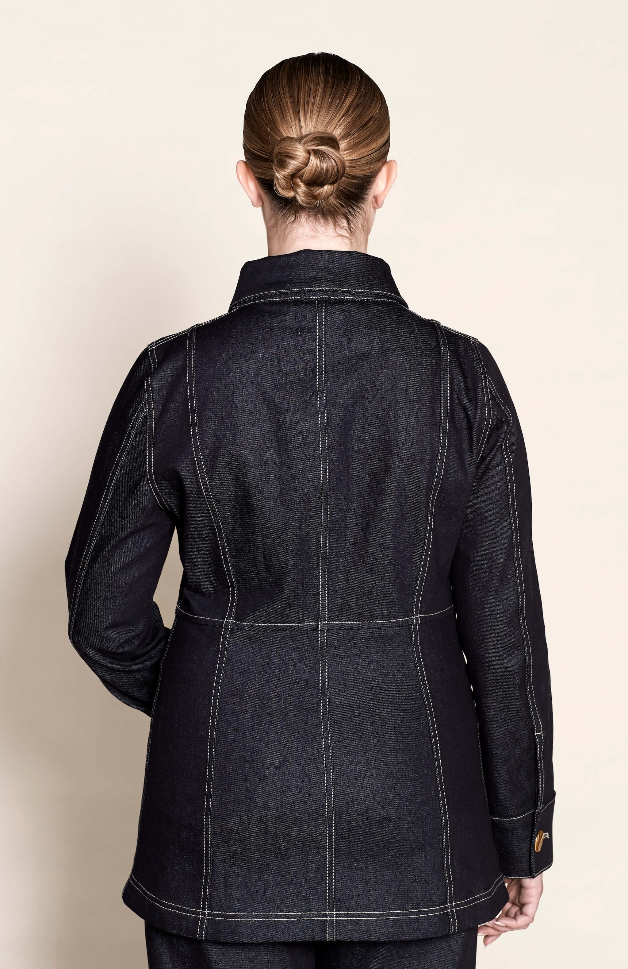 Back view of a tailored Cyme Copenhagen denim jacket, highlighting the fine stitching and structured fit that embody the brand’s Scandinavian design and sustainable fashion ethos.